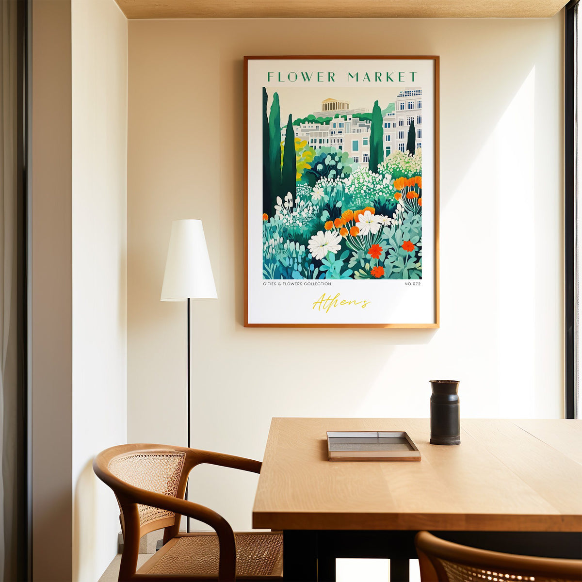 Athens flower market print in an oak frame above a dining table and cane chair