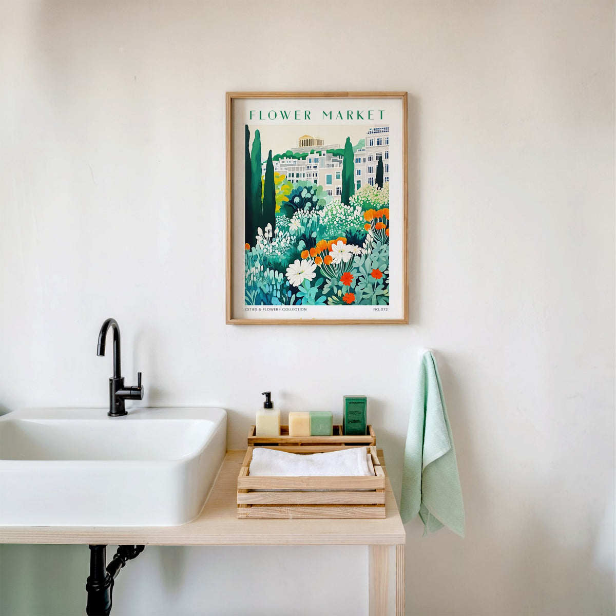 Athens flower market print in an oak frame above a white bathroom sink with folded towels