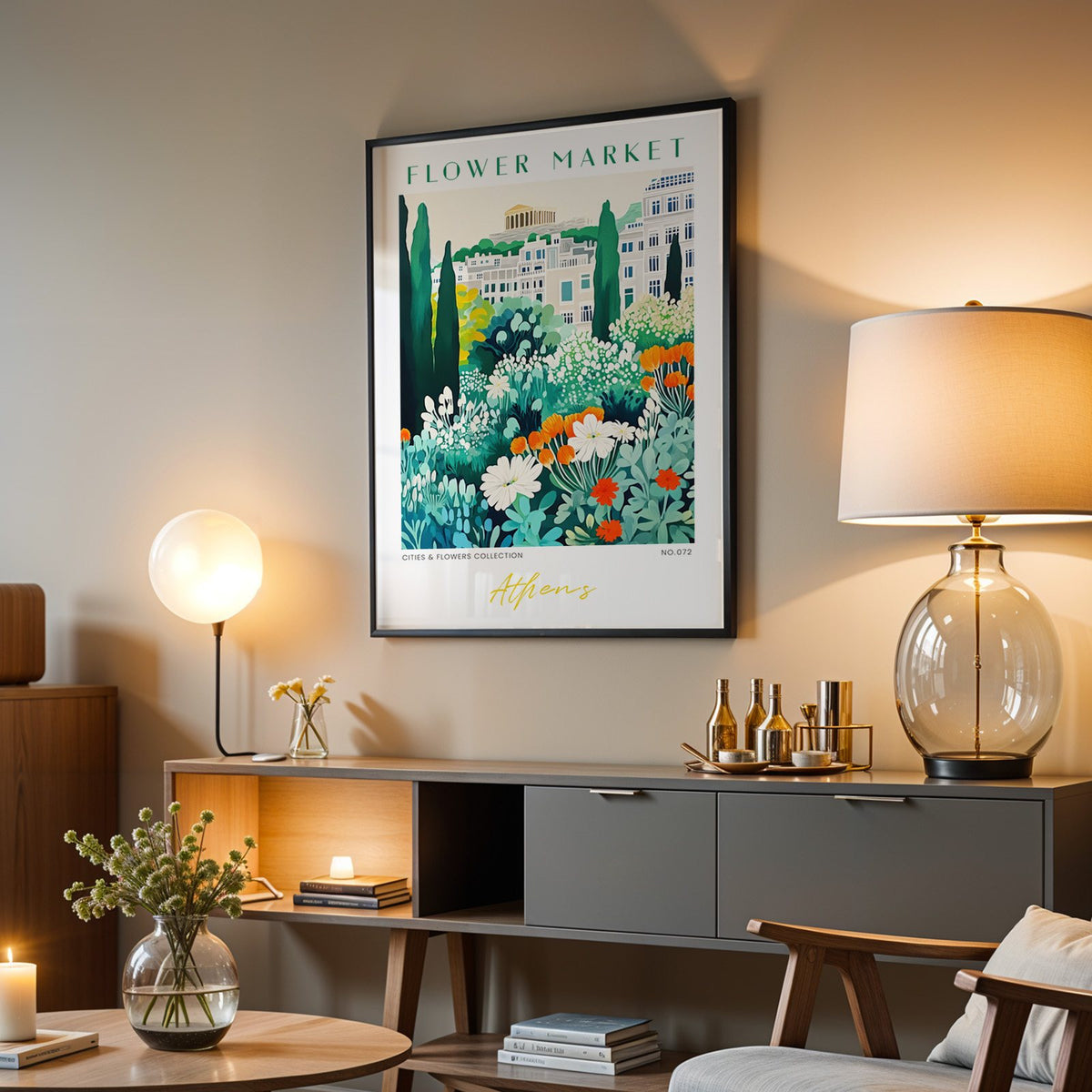 Athens flower market print in a black frame above a grey media console with a glass table lamp