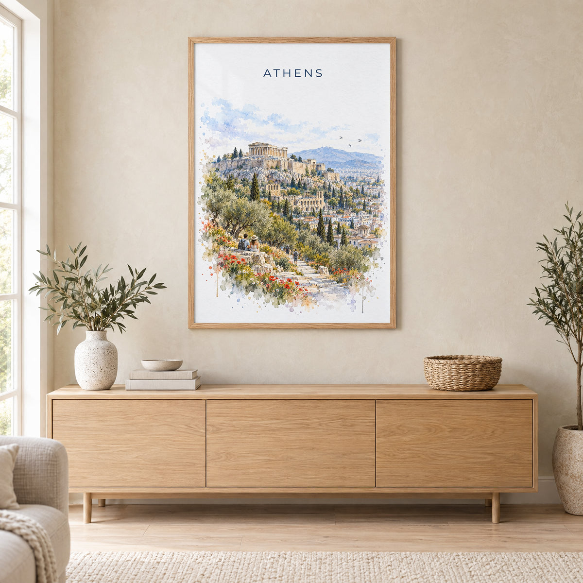 Athens, Greece watercolor print in an oak frame above a light wood sideboard in a Scandinavian living room
