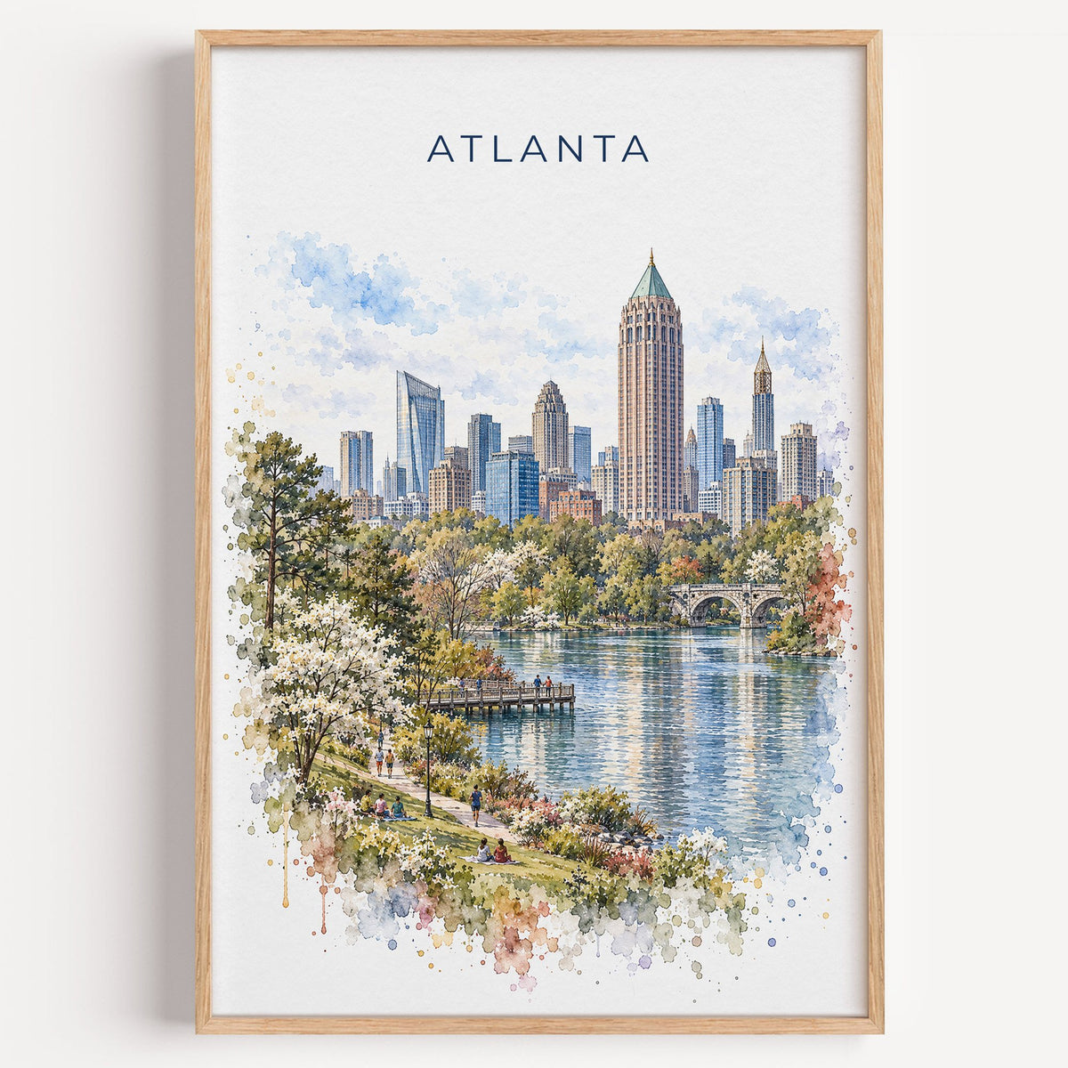 Atlanta watercolor print in a light oak frame on a plain white wall