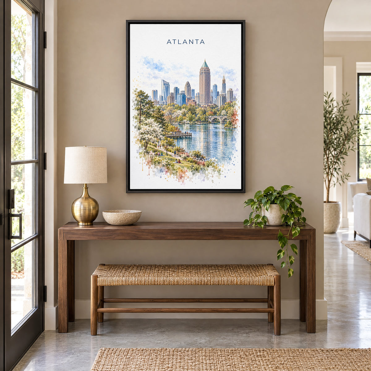 Atlanta watercolor print as a black floater canvas above a walnut console and woven bench in an entryway