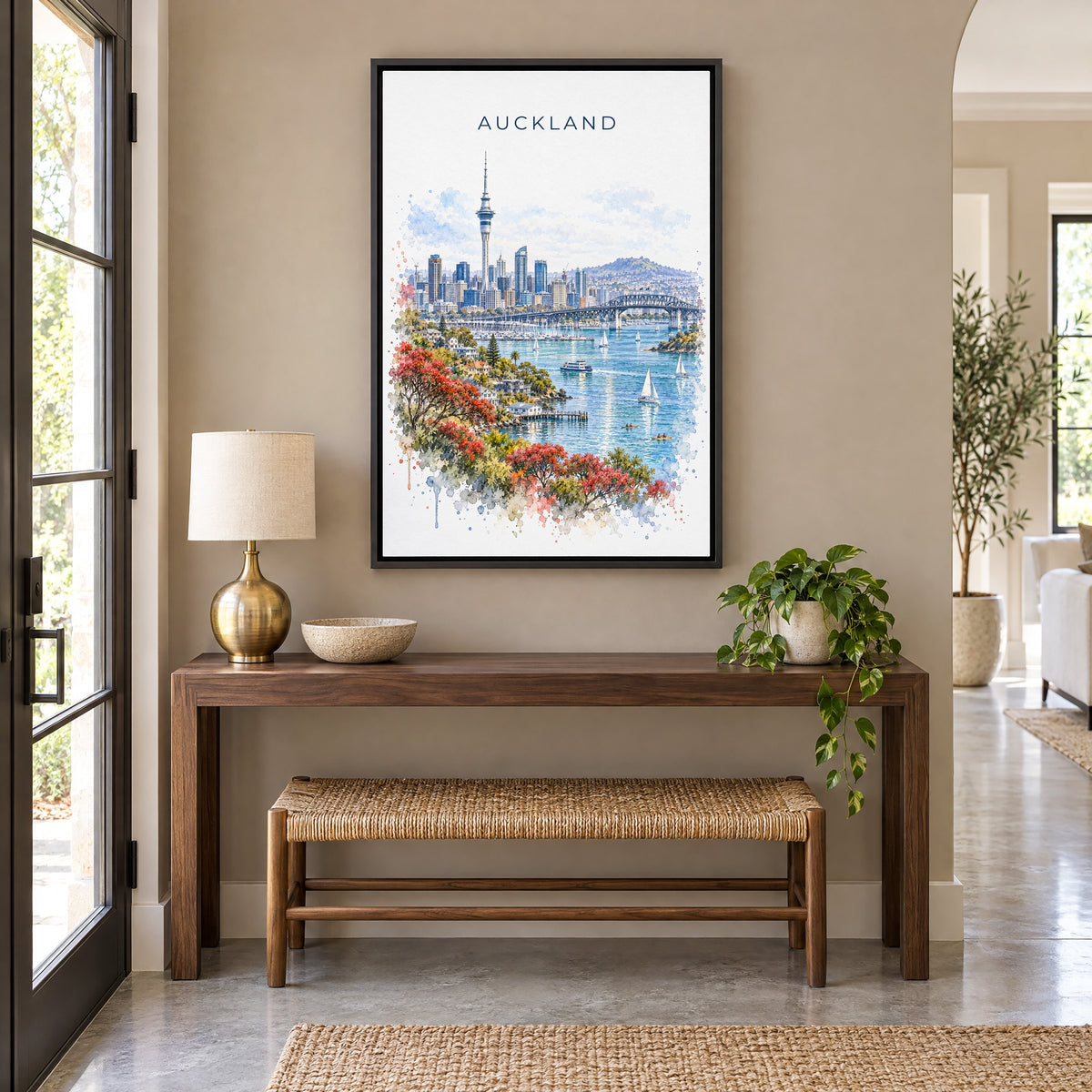 Auckland watercolor print as a black floater canvas above a walnut console and woven bench in an entryway