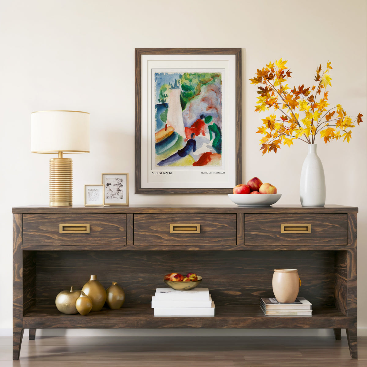 Picnic on the Beach print in a walnut frame above a console with branches