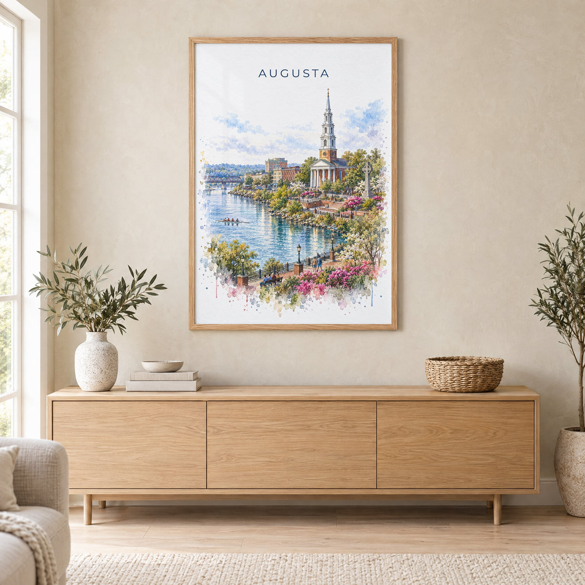 Augusta, Georgia watercolor print in an oak frame above a light wood sideboard in a Scandinavian living room