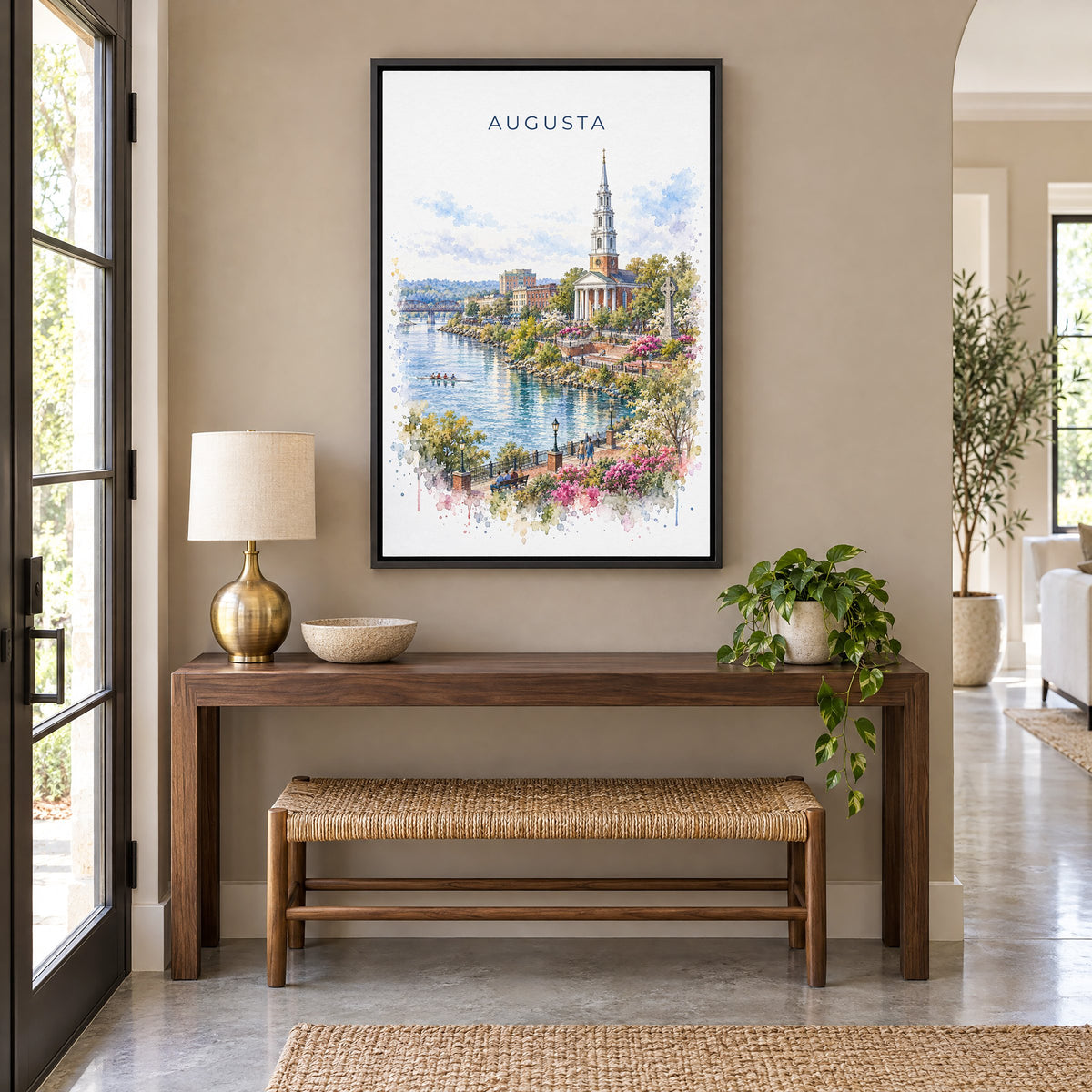 Augusta, Georgia watercolor print as a black floater canvas above a walnut console and woven bench in an entryway