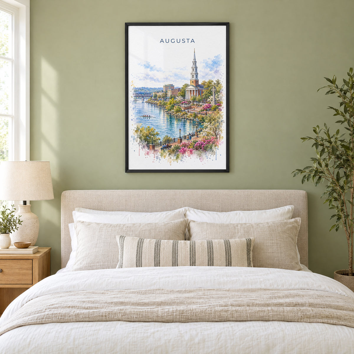 Augusta, Georgia watercolor print in a black frame above an upholstered headboard in a sage green bedroom