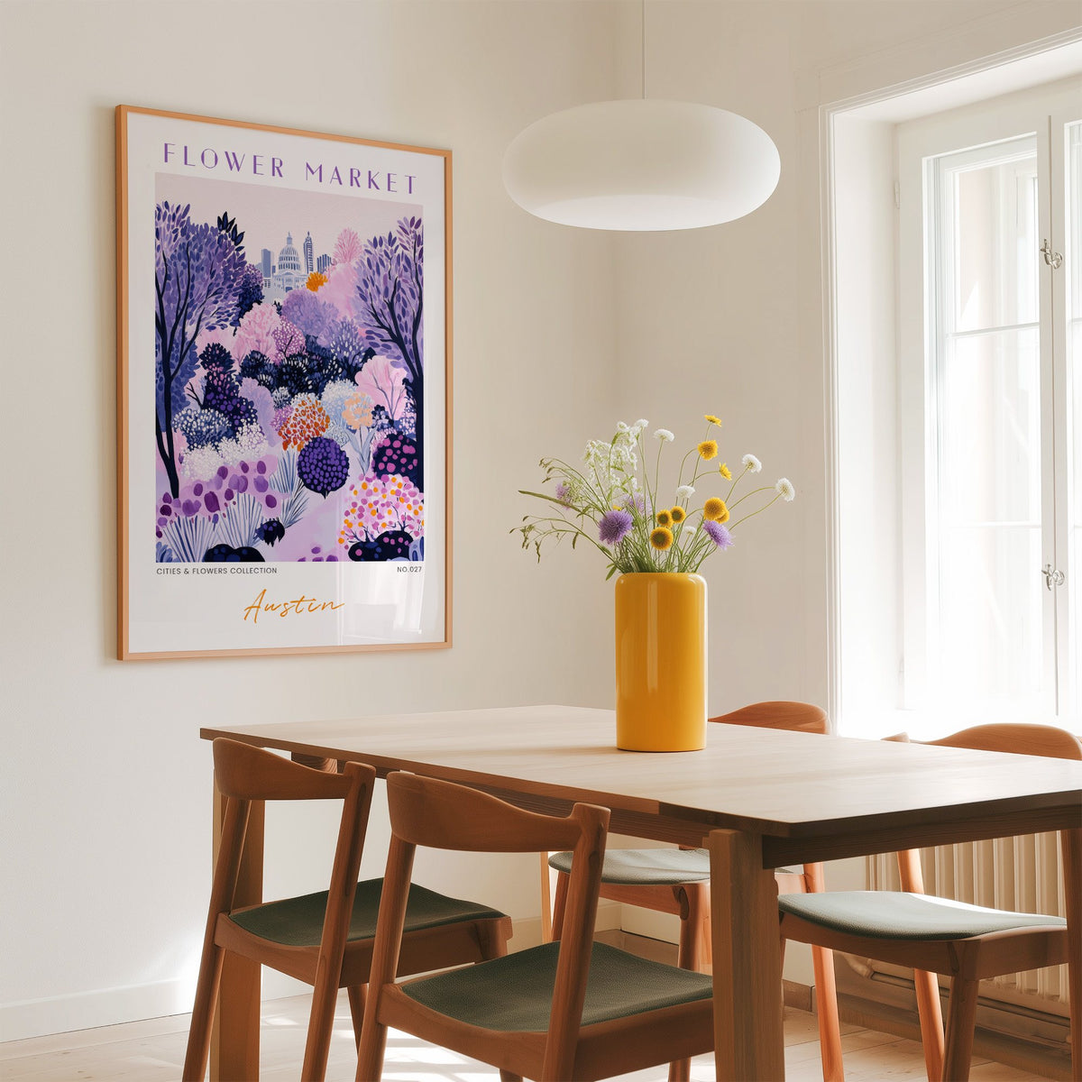 Austin flower market print in an oak frame above a dining table with a yellow vase and white pendant light