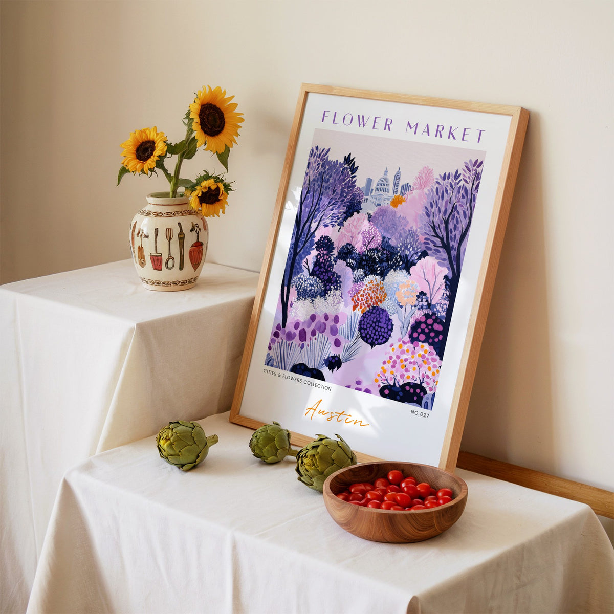Austin flower market print in an oak frame leaning on a linen-draped table beside a vase of sunflowers
