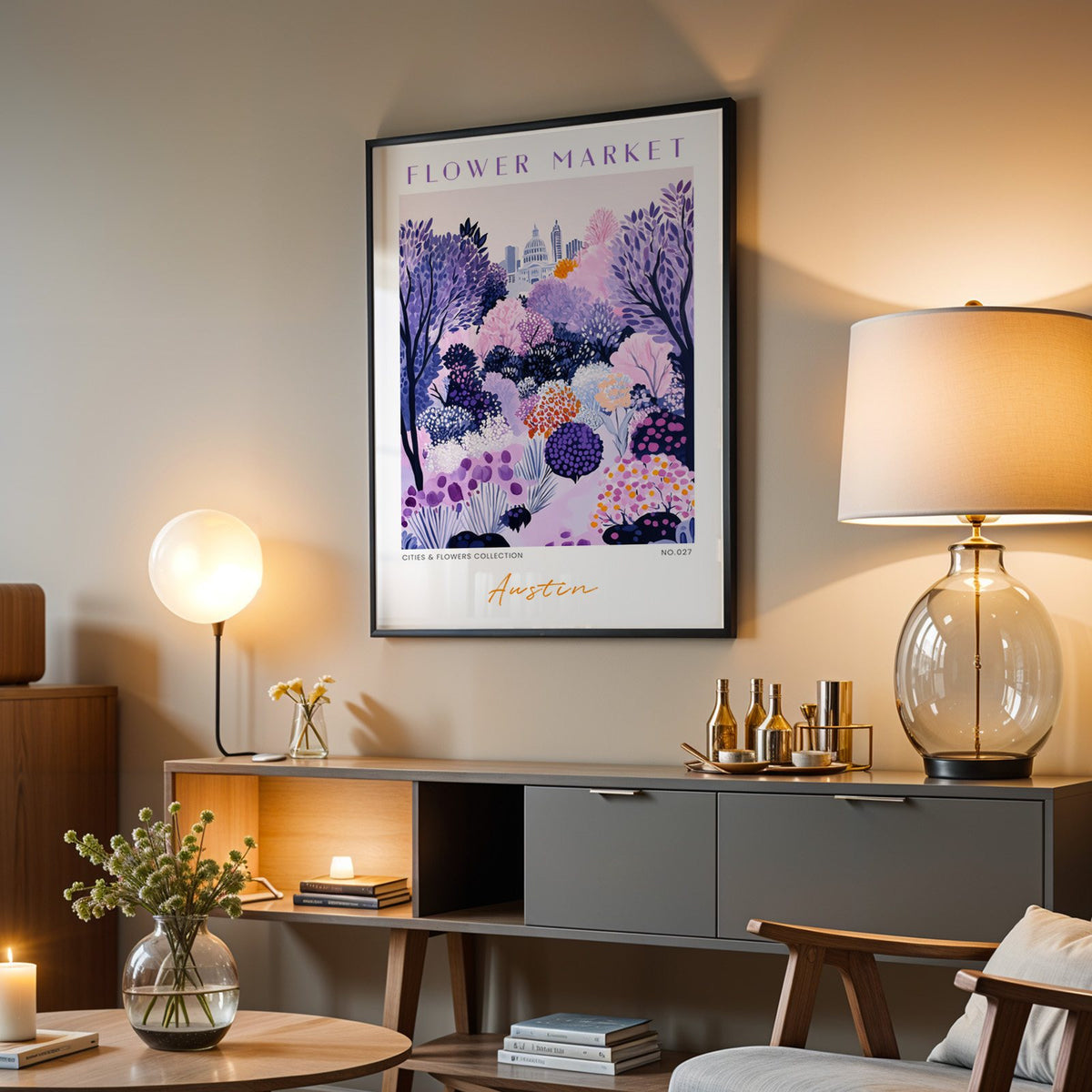 Austin flower market print in a black frame above a grey media console with a glass table lamp