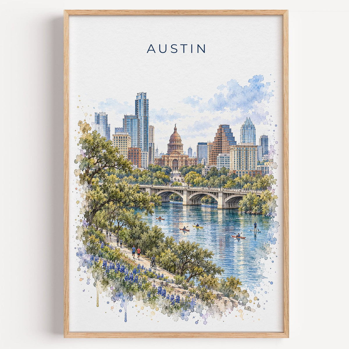 Austin watercolor print in a light oak frame on a plain white wall