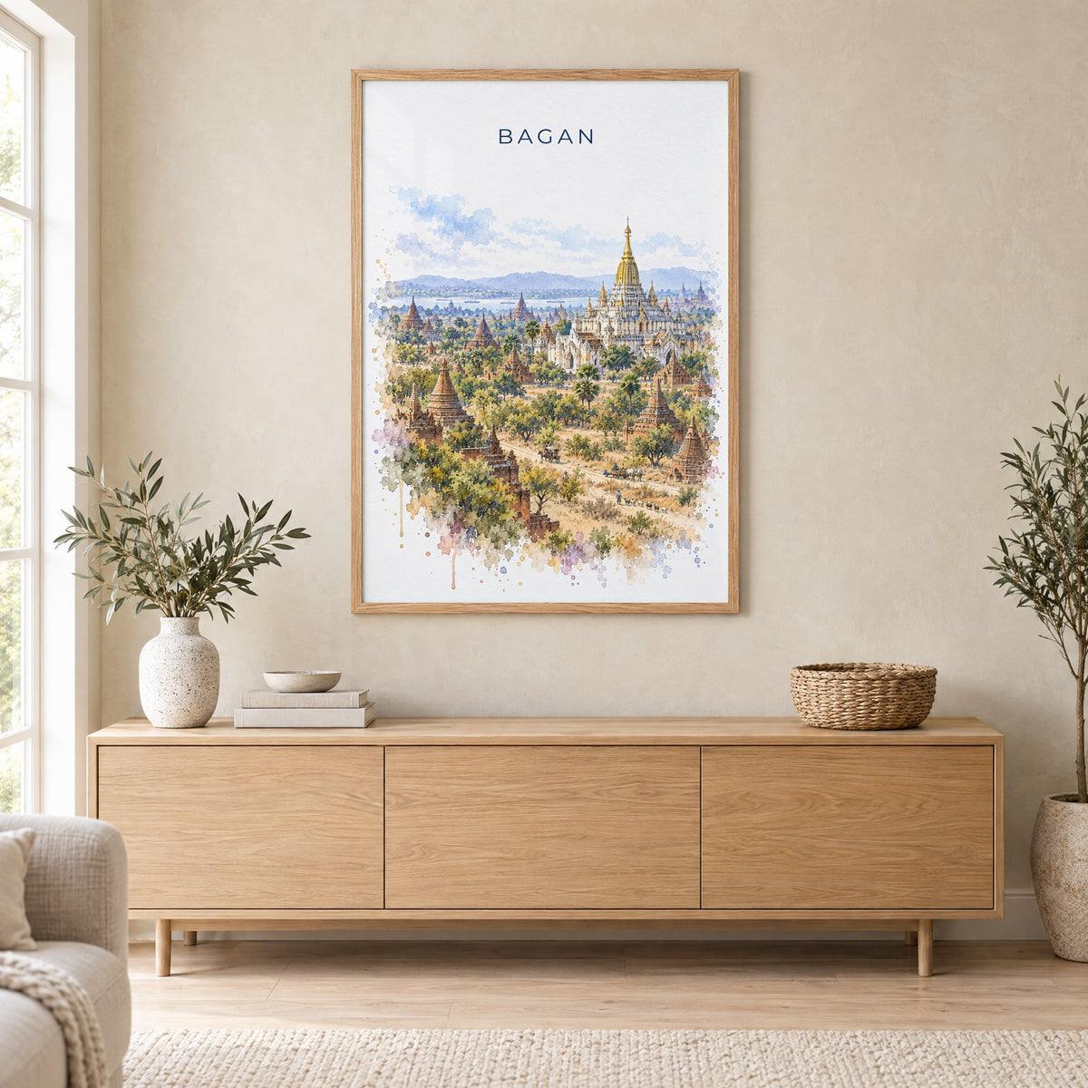 Bagan watercolor print in an oak frame above a light wood sideboard in a Scandinavian living room