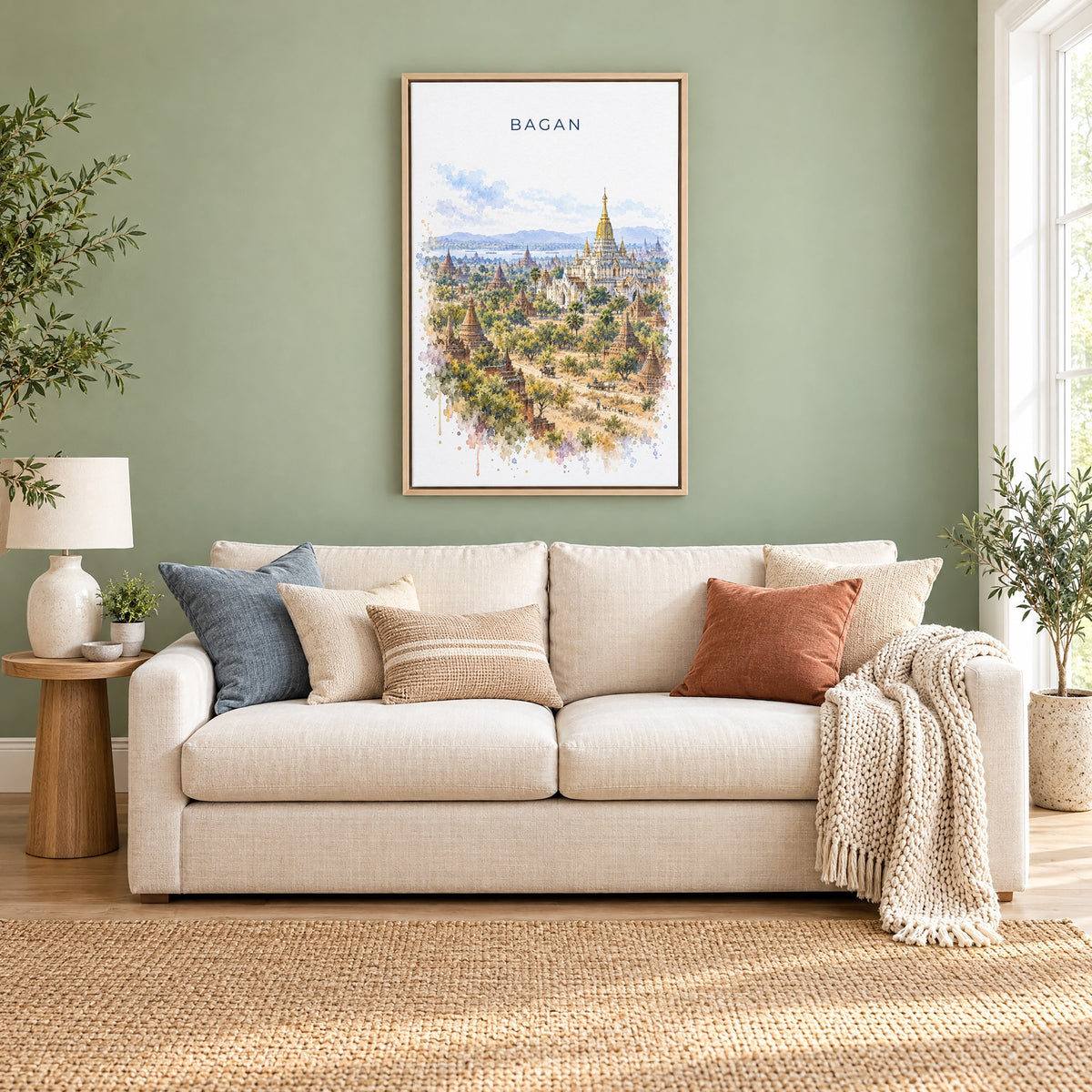 Bagan watercolor print as a natural floater canvas above a cream linen sofa on a sage green wall