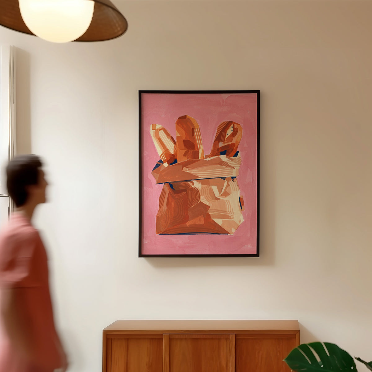 Bread bag still life print in a black frame in a hallway under a rattan pendant