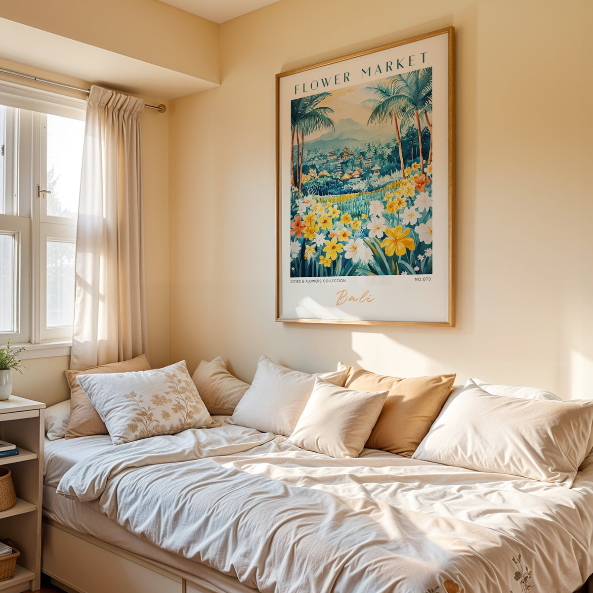 Bali flower market print in an oak frame above a cream daybed in a sunny bedroom
