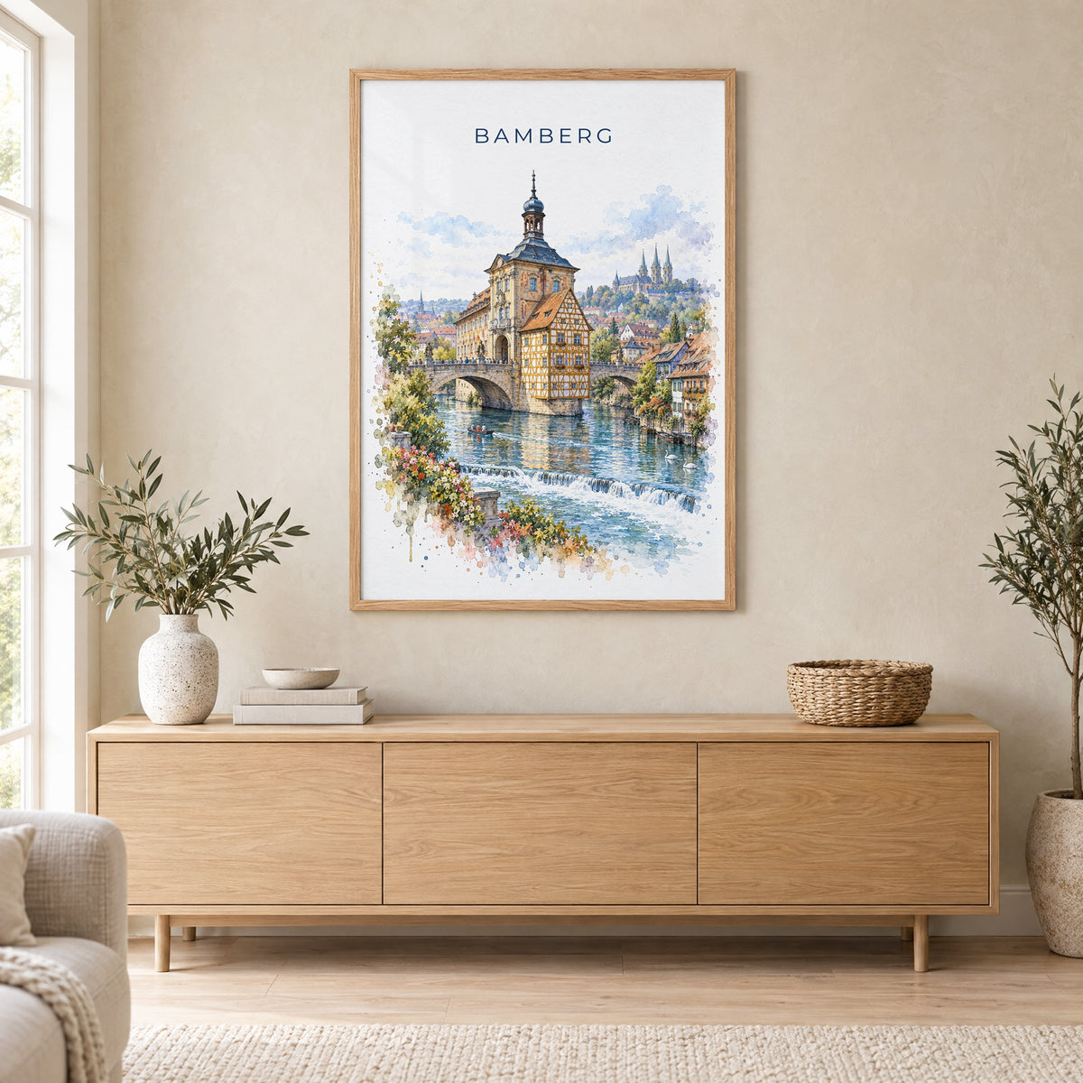 Bamberg watercolor print in an oak frame above a light wood sideboard in a Scandinavian living room