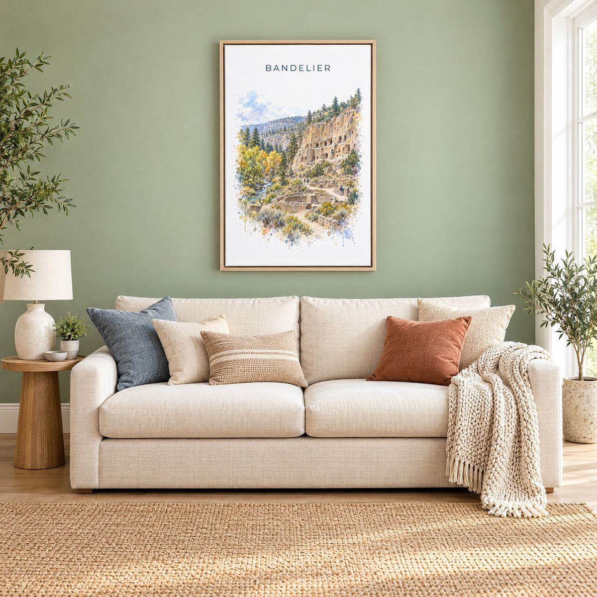 Bandelier National Monument watercolor print as a natural floater canvas above a cream linen sofa on a sage green wall