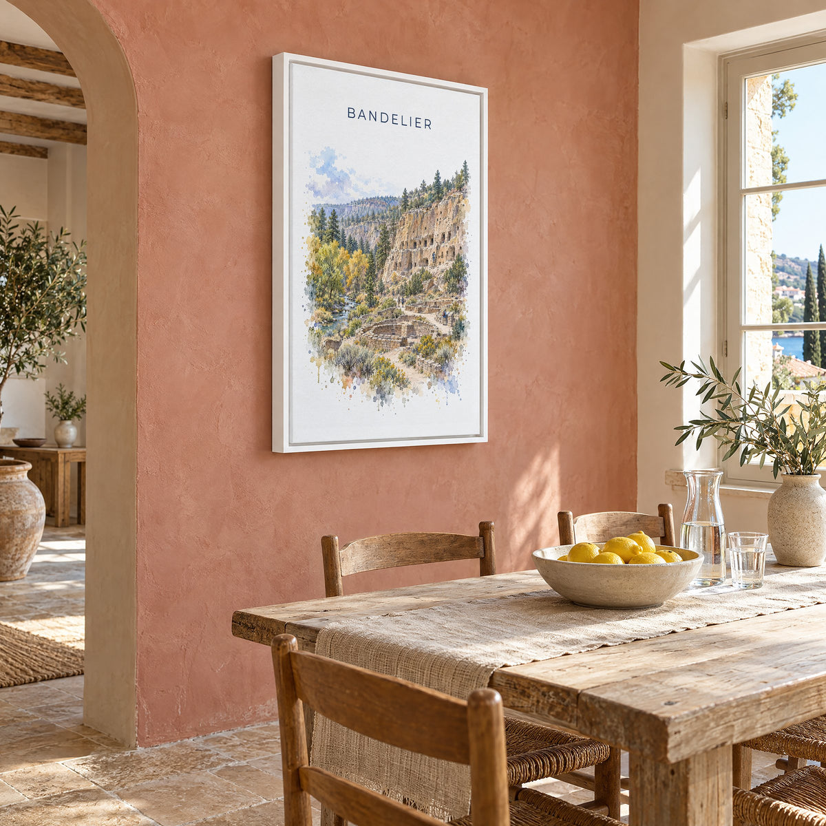Bandelier National Monument watercolor print as a white floater canvas on a terracotta wall above a rustic dining table