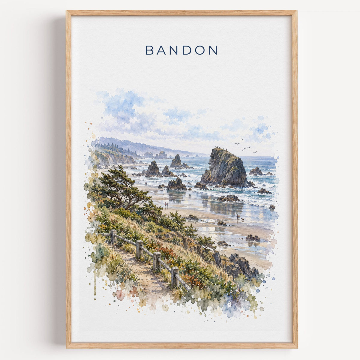 Bandon, Oregon watercolor print in a light oak frame on a plain white wall