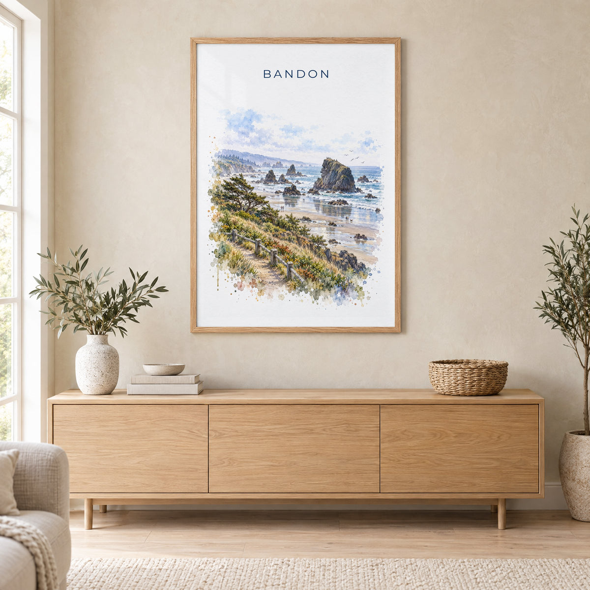 Bandon, Oregon watercolor print in an oak frame above a light wood sideboard in a Scandinavian living room
