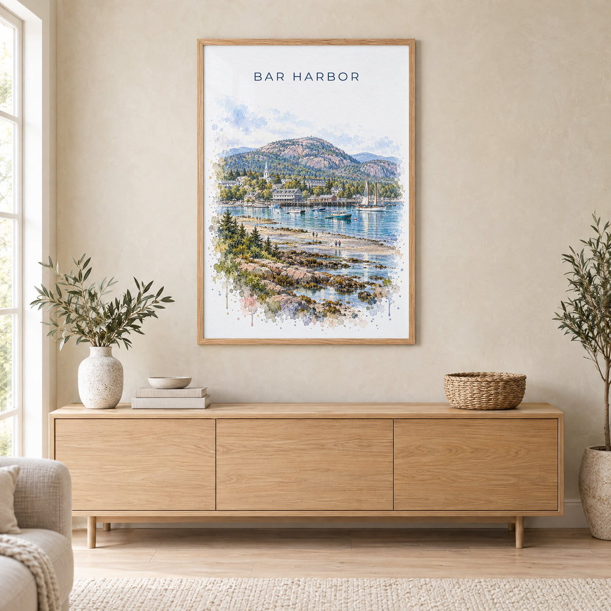 Bar Harbor watercolor print in an oak frame above a light wood sideboard in a Scandinavian living room