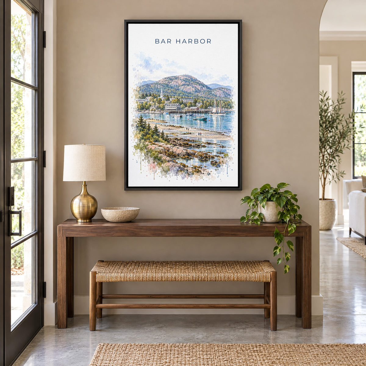 Bar Harbor watercolor print as a black floater canvas above a walnut console and woven bench in an entryway