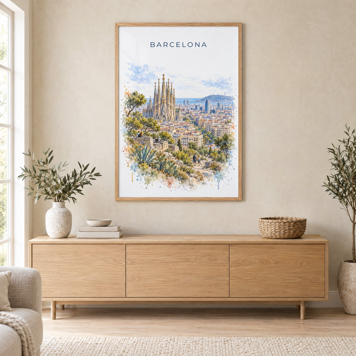 Barcelona watercolor print in an oak frame above a light wood sideboard in a Scandinavian living room