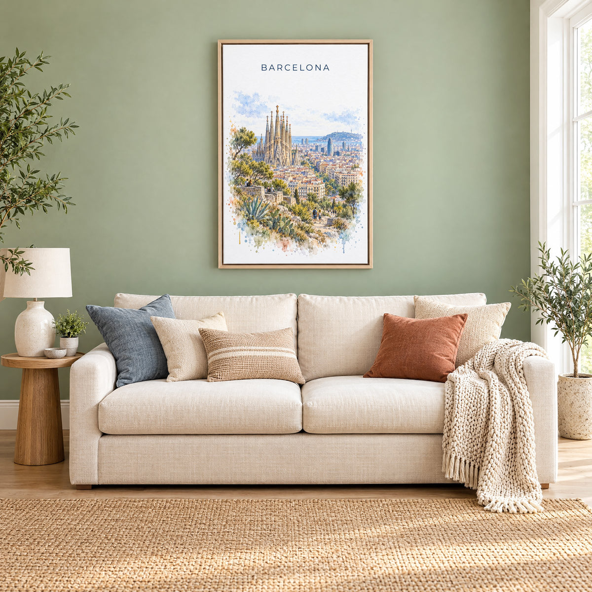 Barcelona watercolor print as a natural floater canvas above a cream linen sofa on a sage green wall