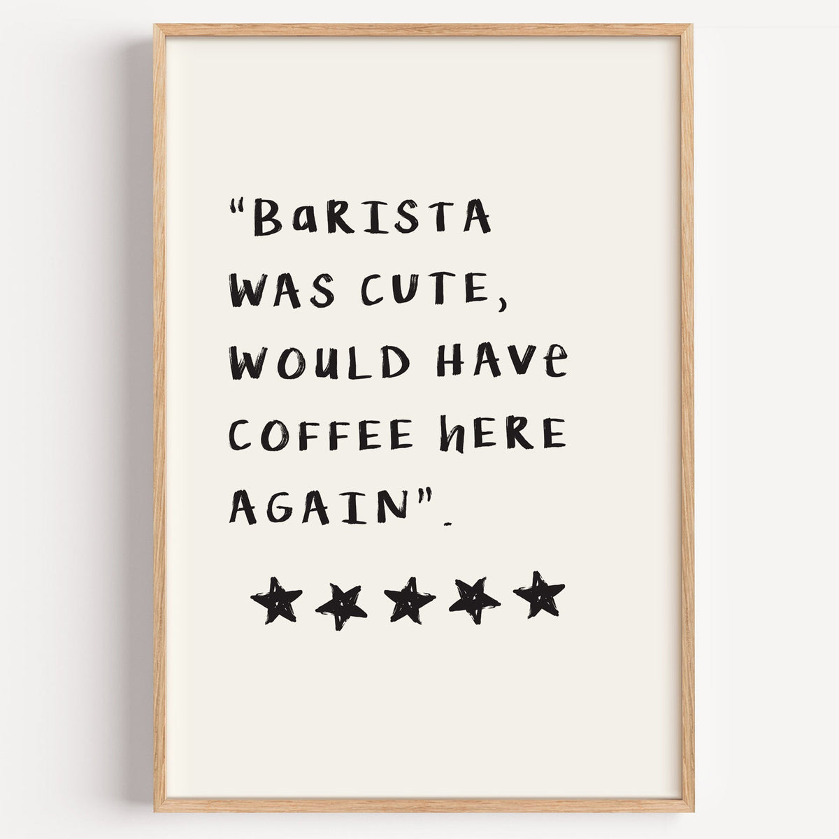 Barista was cute coffee quote print in a light oak frame on a plain white wall