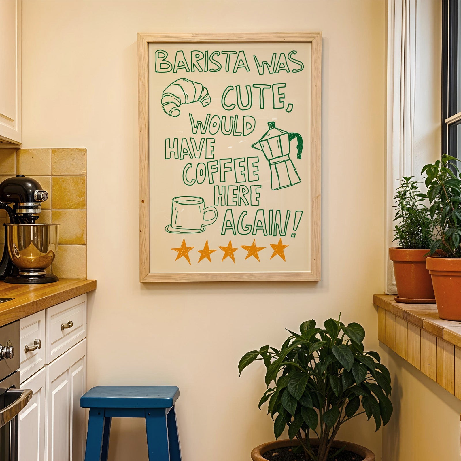 Green outline barista print in a wood frame on a yellow tiled kitchen wall