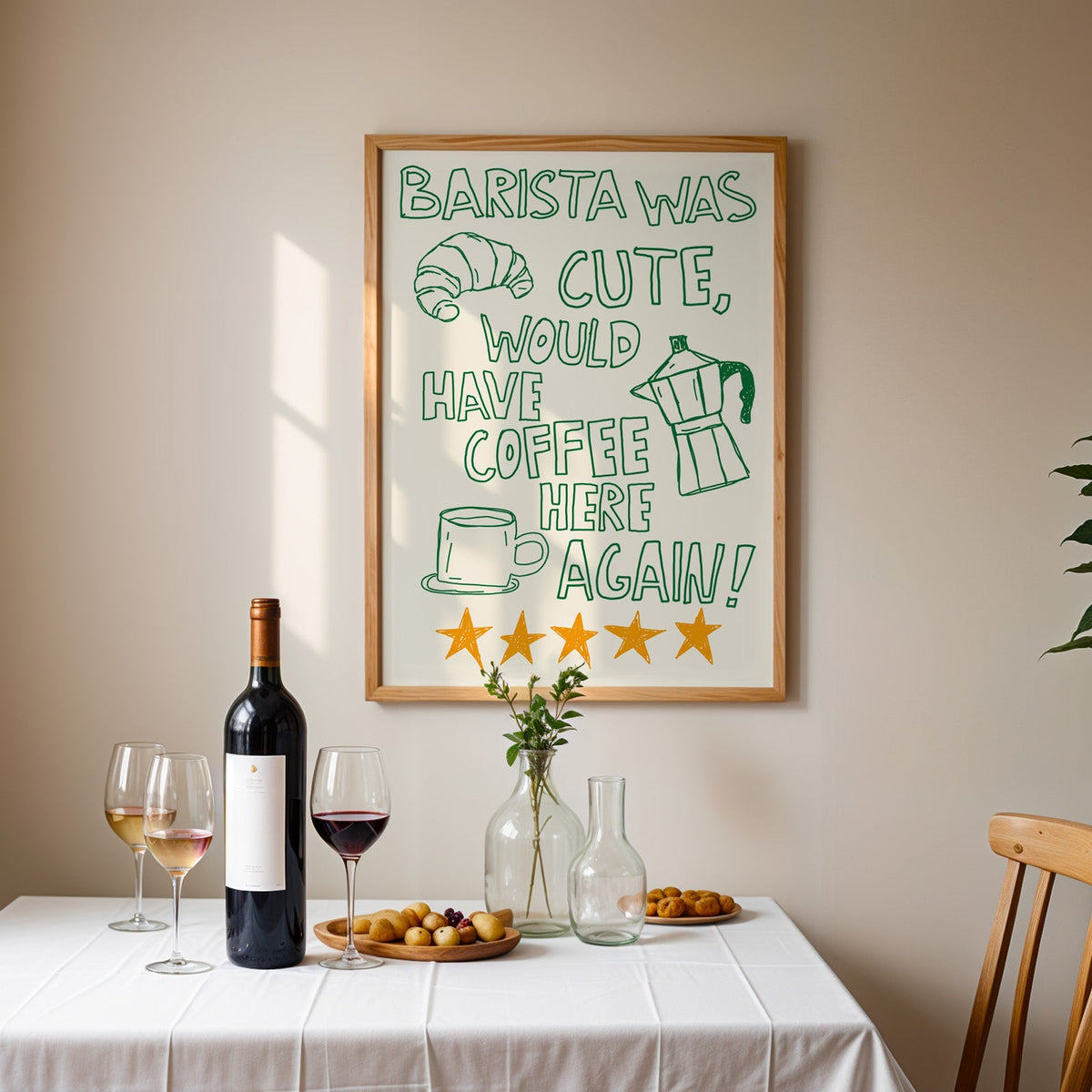 Green outline barista print in an oak frame above a table laid with red wine and glasses