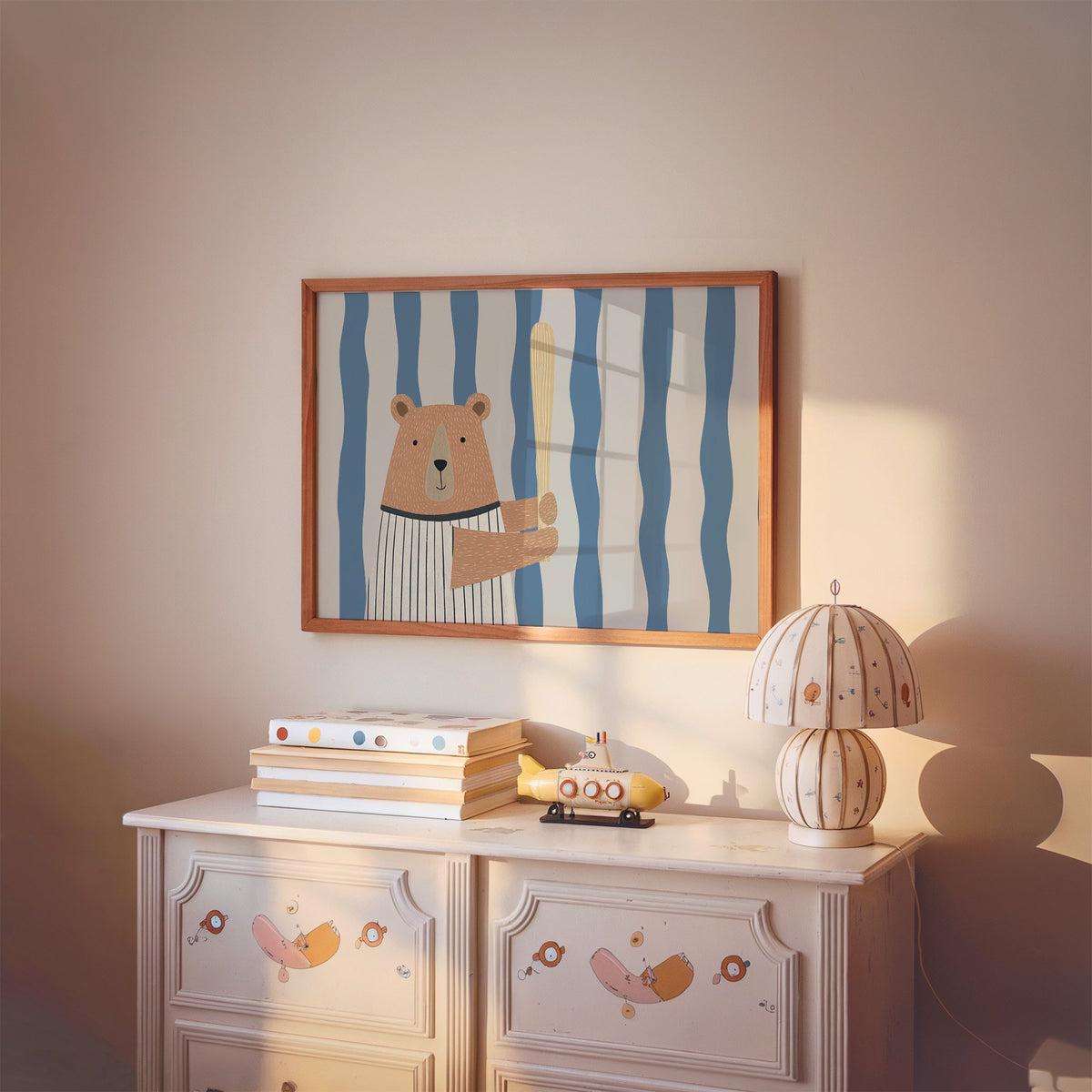 Landscape baseball bear blue stripe nursery print in a cherry wood frame above a painted dresser and lamp