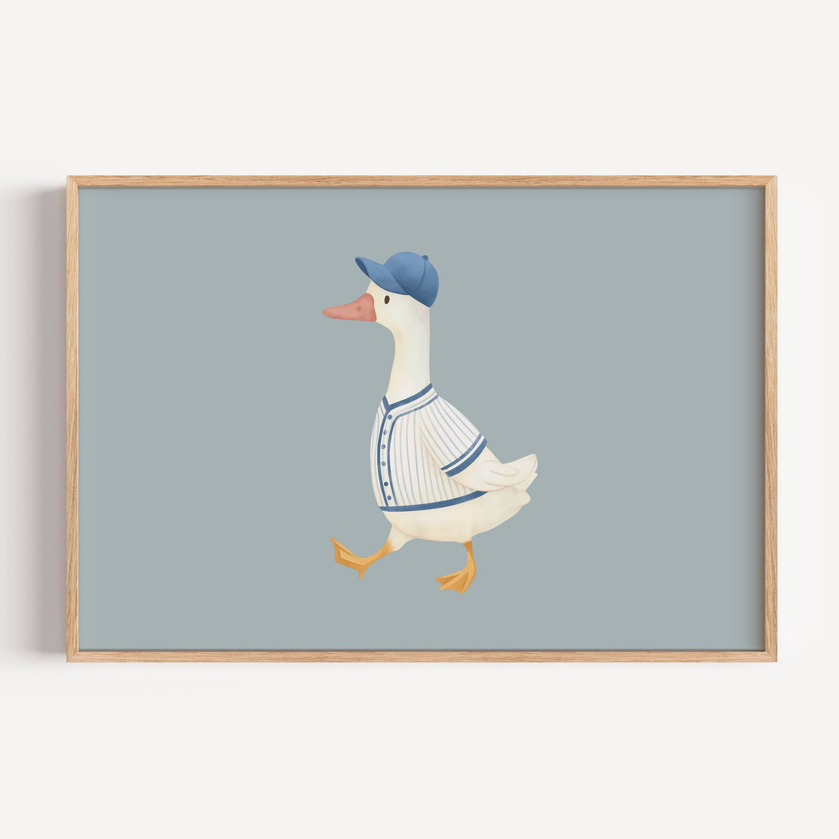 Landscape baseball bird blue cap nursery print in a light oak frame on a plain white wall