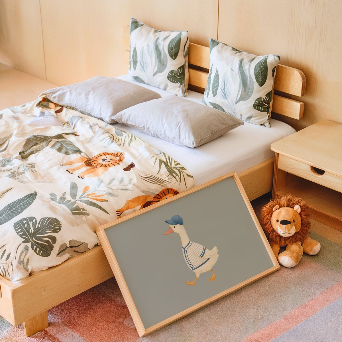 Landscape baseball bird blue cap nursery print in an oak frame leaning on a kids bed by a lion plush