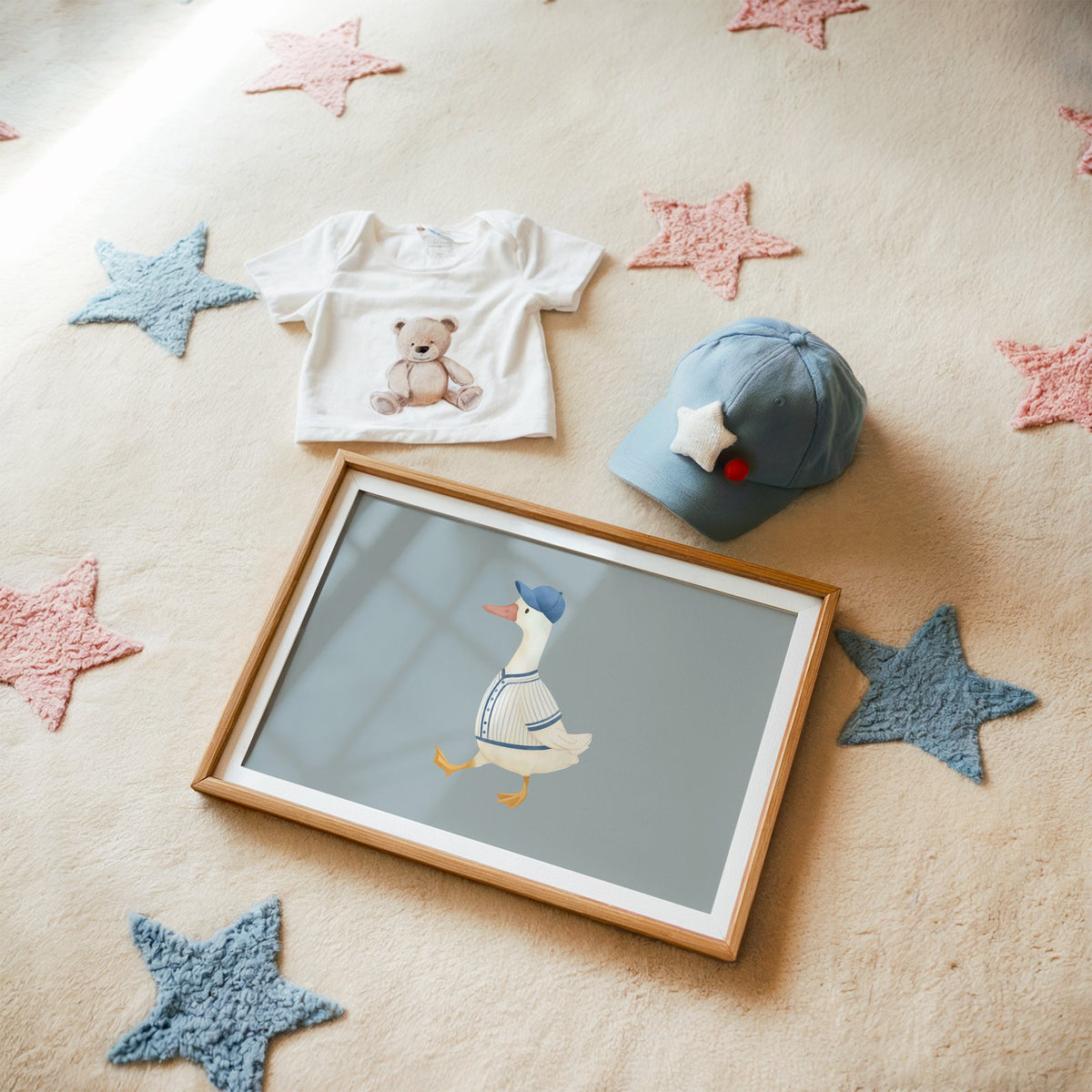 Landscape baseball bird blue cap nursery print in a matted oak frame on a star rug with a baby tee