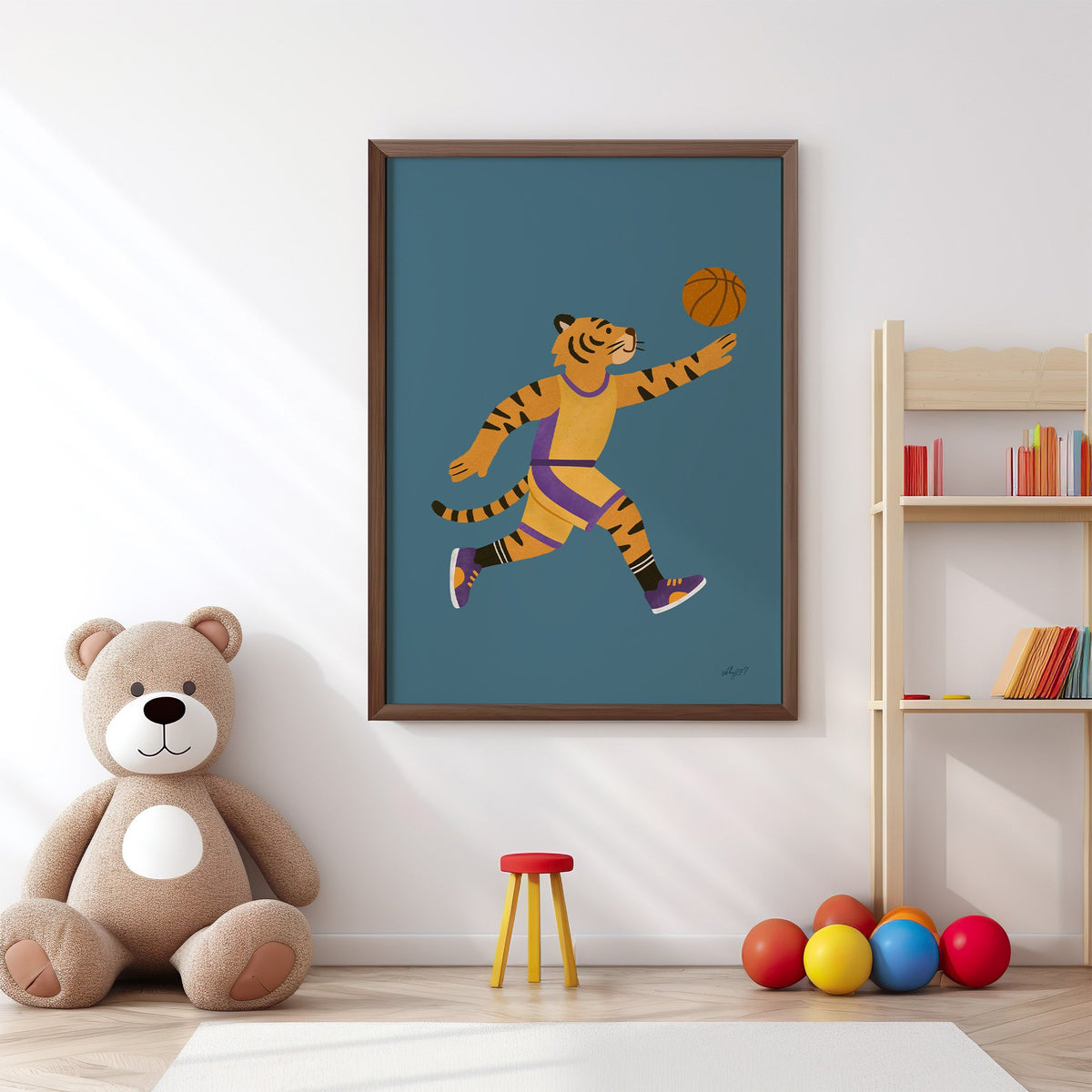 Tiger playing basketball nursery print in a walnut frame above a big teddy bear by a bookshelf