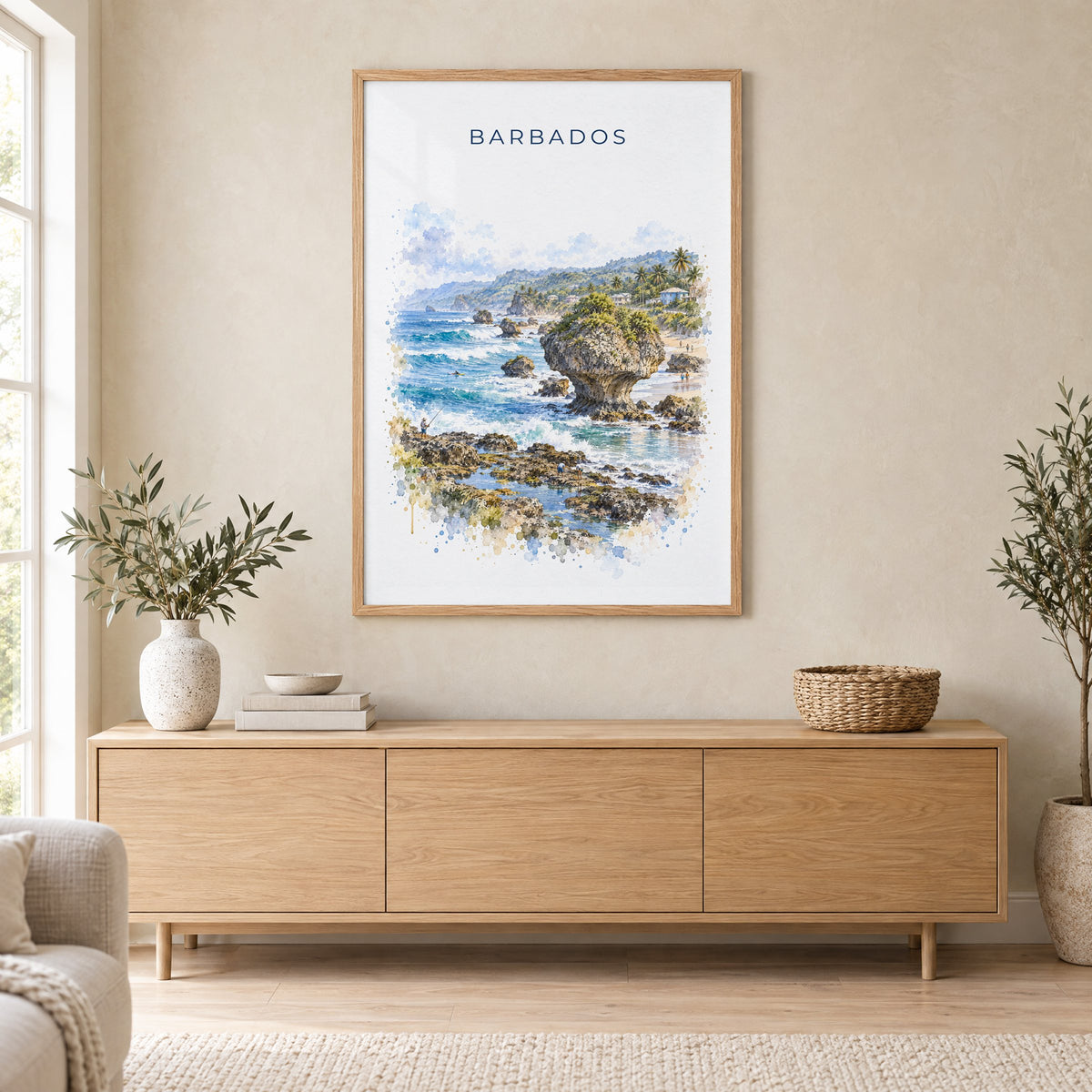 Barbados watercolor print in an oak frame above a light wood sideboard in a Scandinavian living room