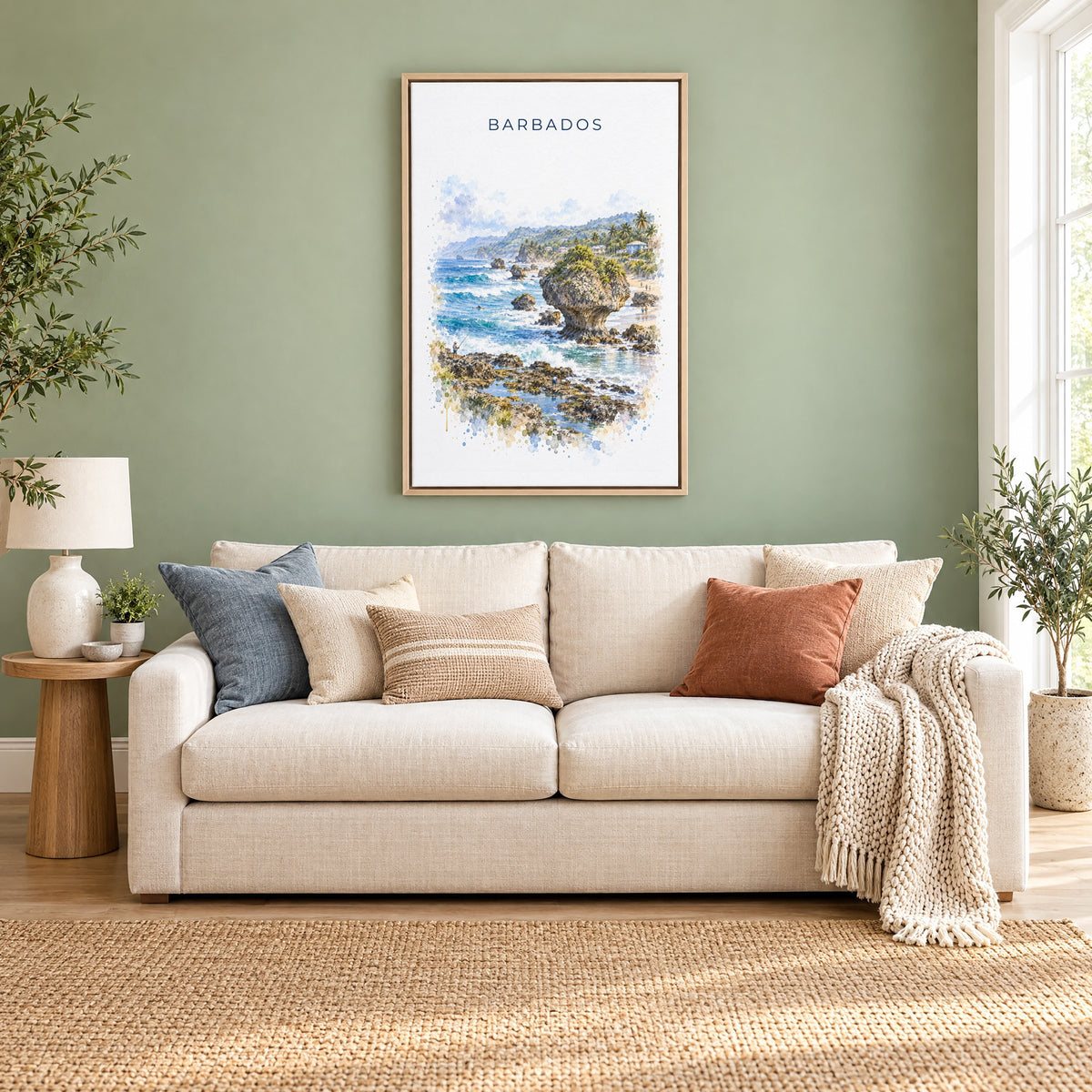 Barbados watercolor print as a natural floater canvas above a cream linen sofa on a sage green wall