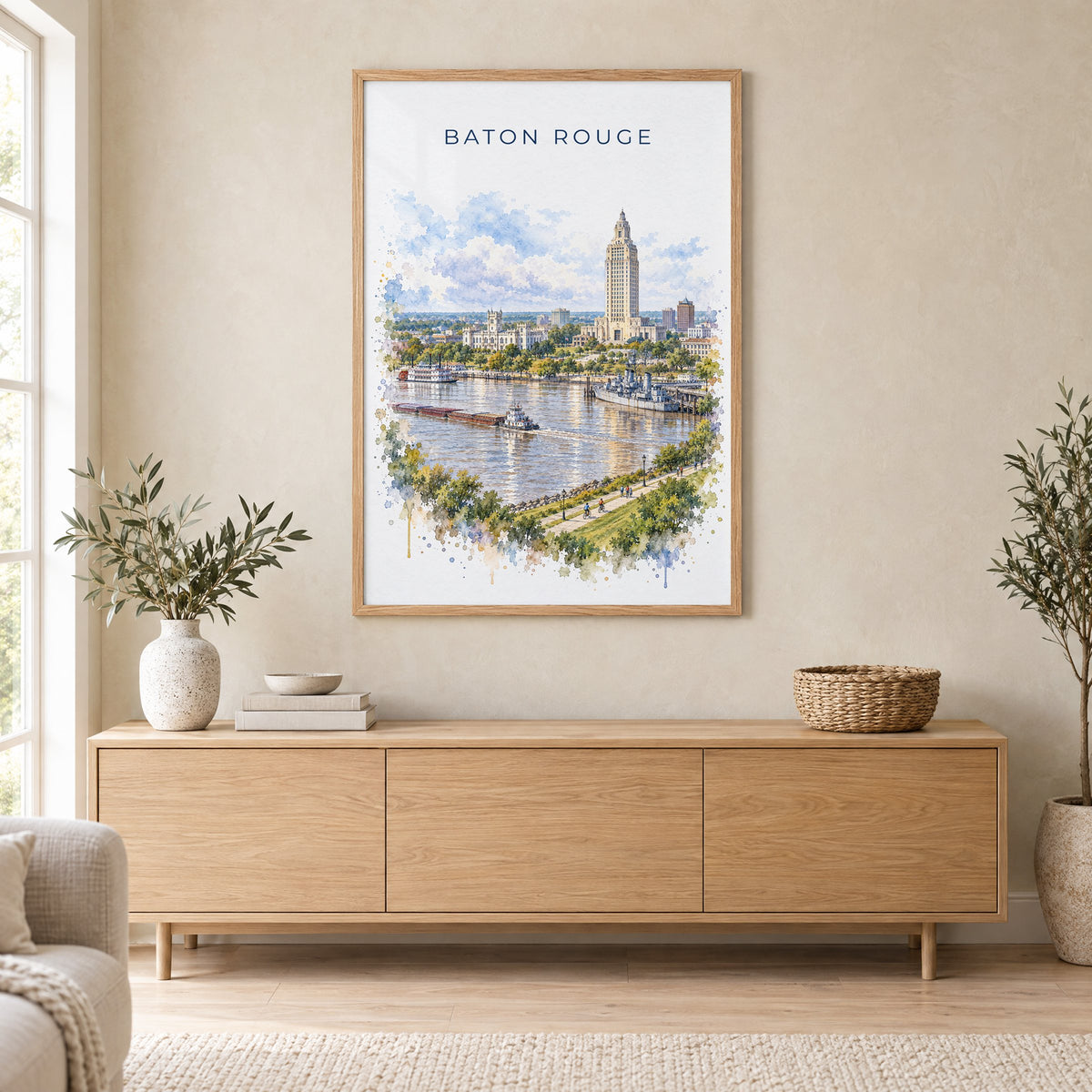 Baton Rouge watercolor print in an oak frame above a light wood sideboard in a Scandinavian living room