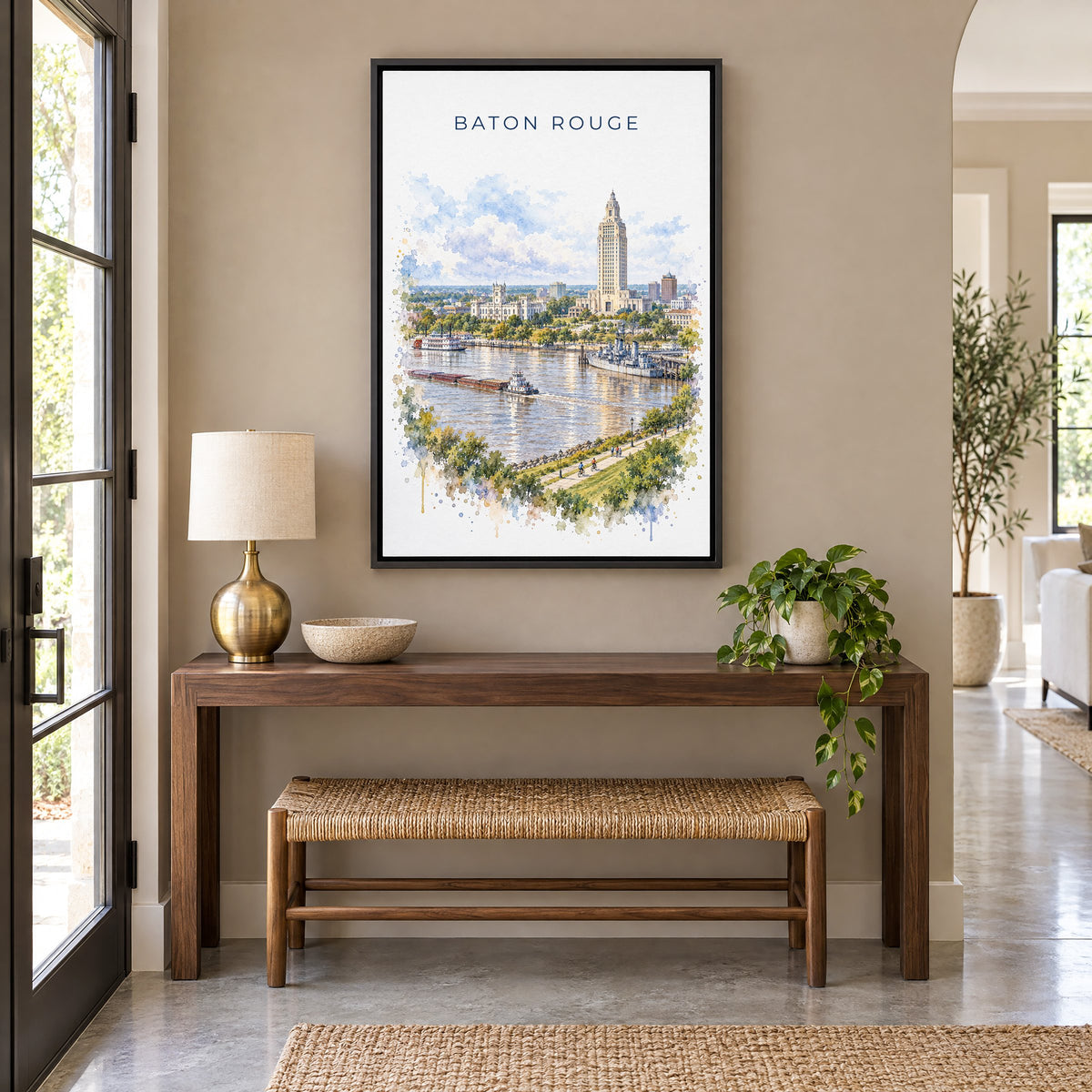 Baton Rouge watercolor print as a black floater canvas above a walnut console and woven bench in an entryway