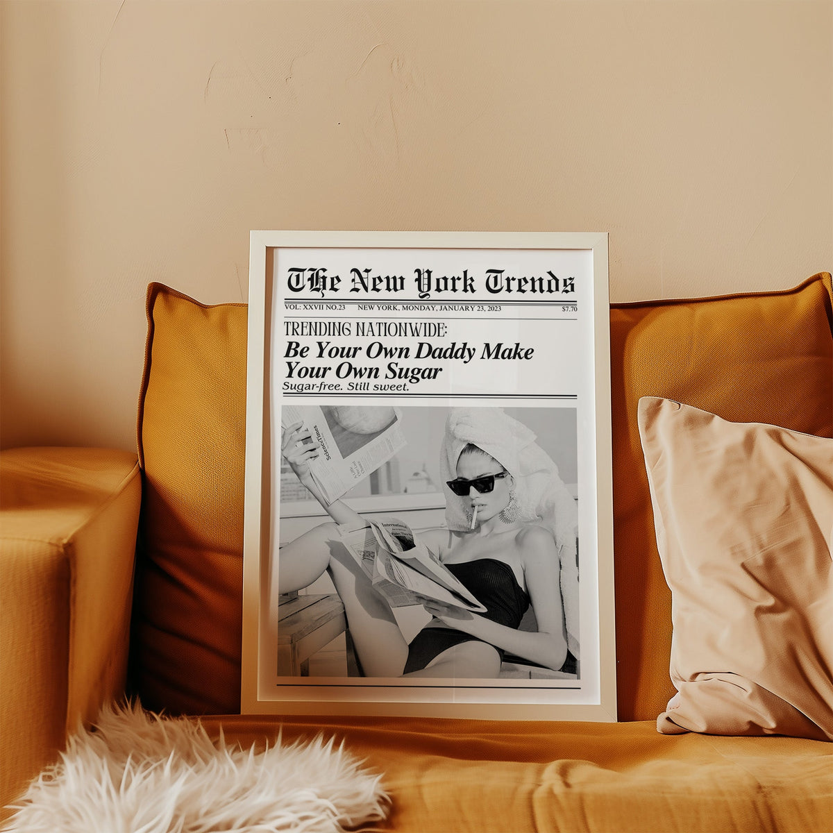 Woman reading newspapers on rooftop mock front page print in a white frame leaning on a mustard velvet sofa