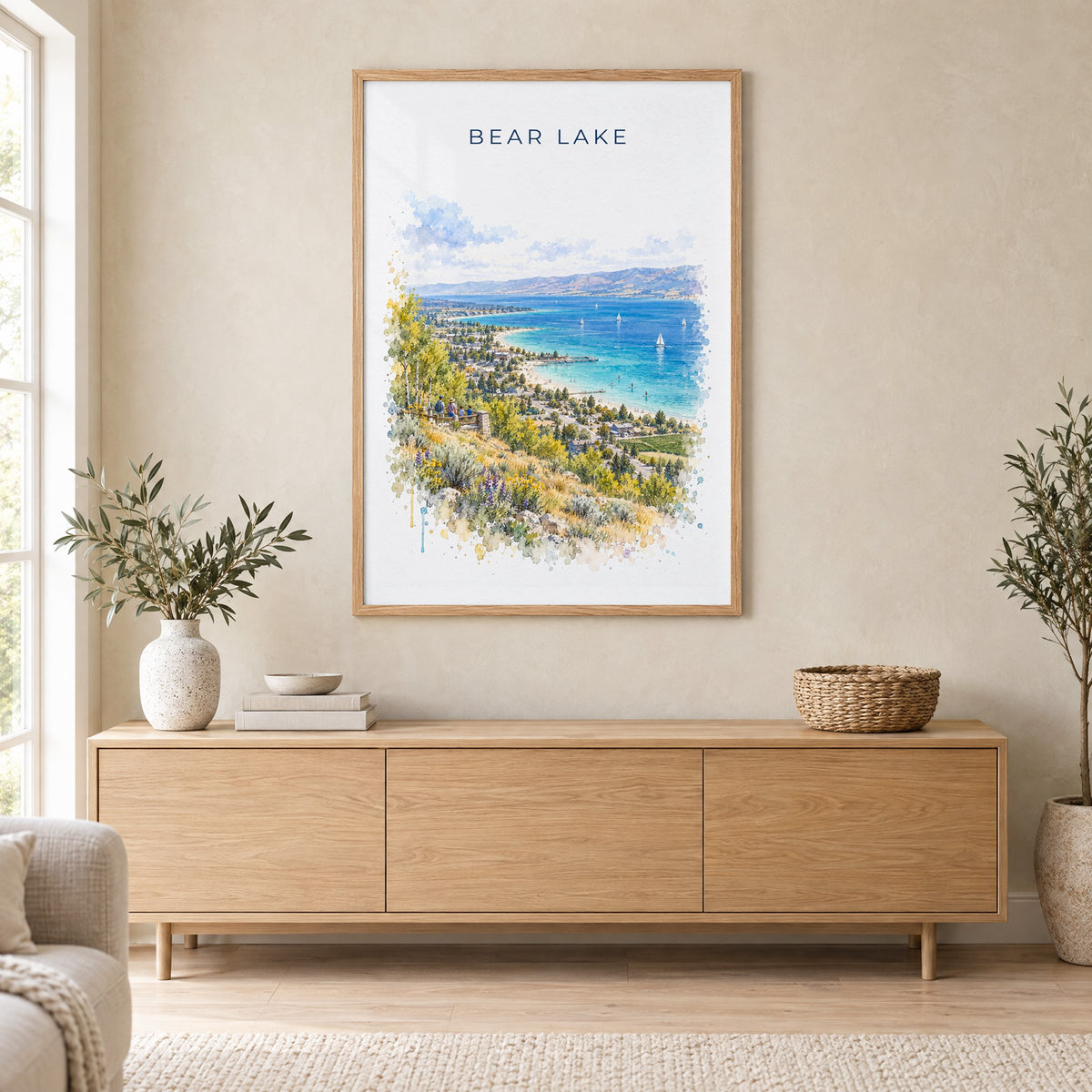 Bear Lake watercolor print in an oak frame above a light wood sideboard in a Scandinavian living room