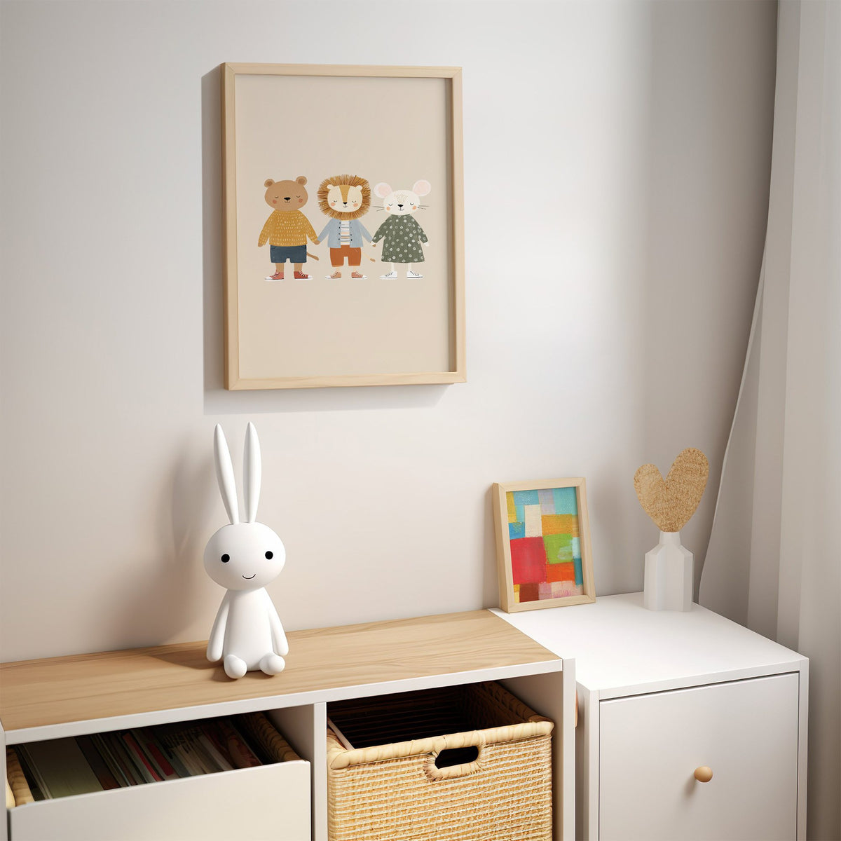 Three friends holding hands nursery print in an oak frame above a kids cubby shelf with a woven basket and bunny lamp