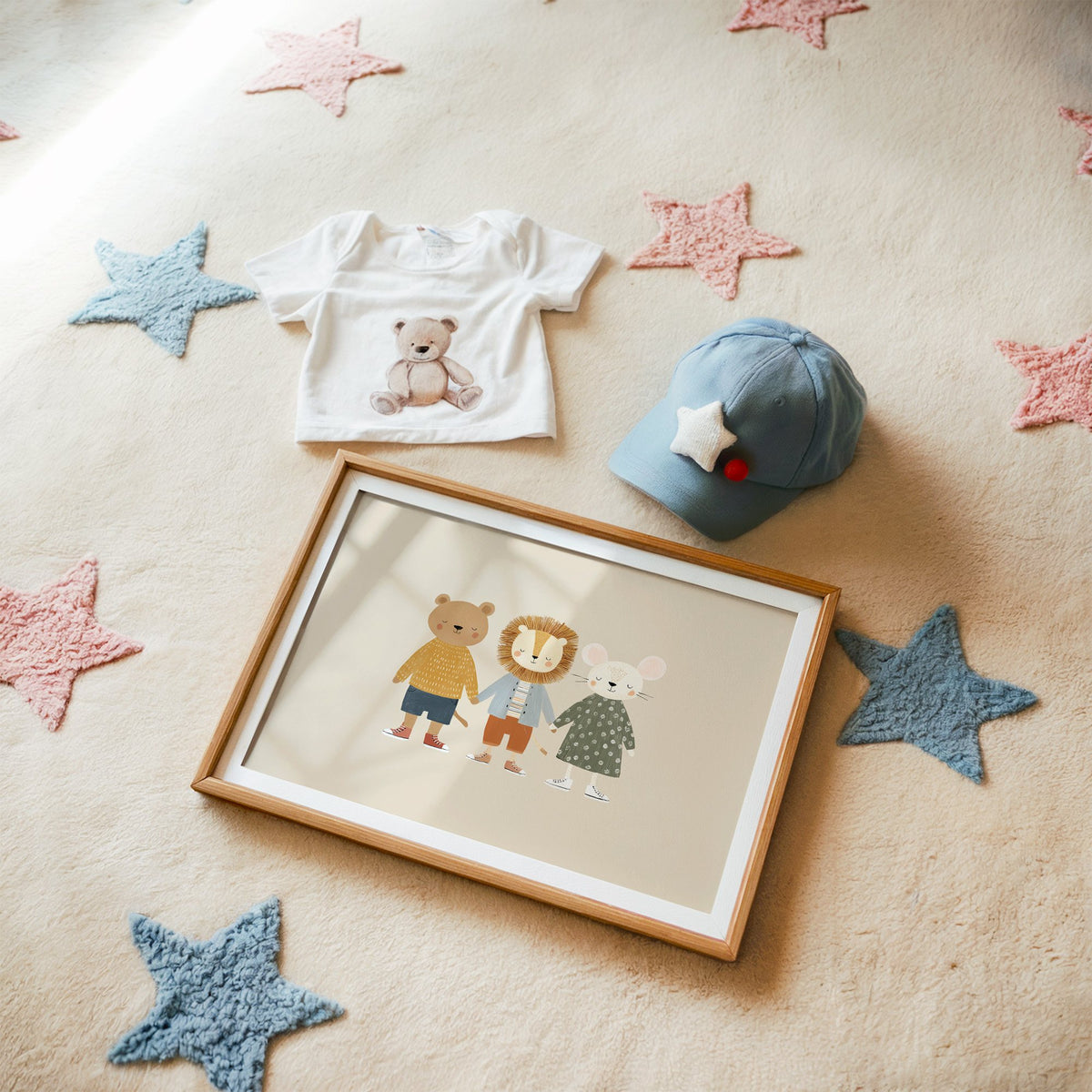 Landscape three friends holding hands nursery print in a matted oak frame on a star rug with a baby tee