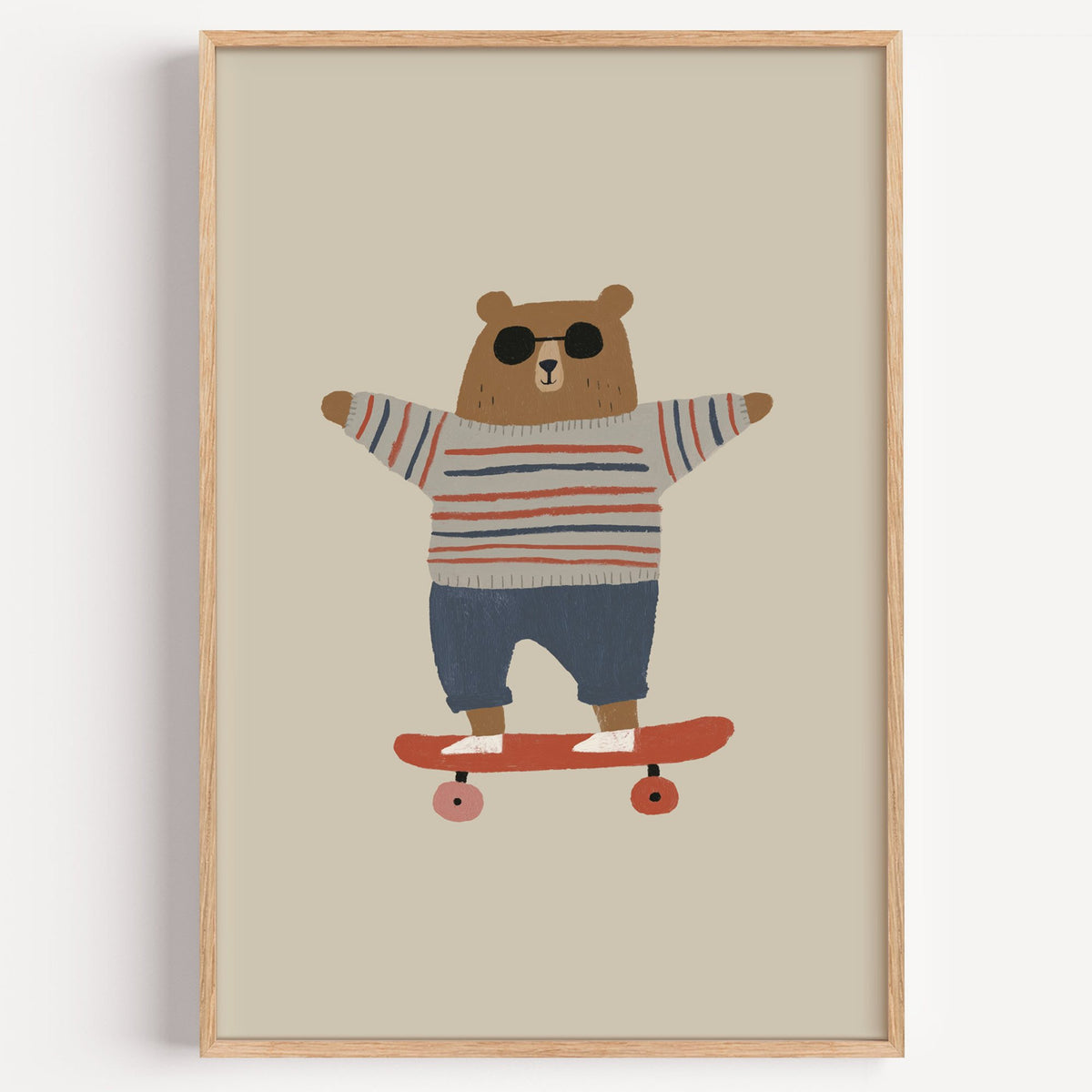 Skateboard bear striped sweater nursery print in a light oak frame on a plain white wall