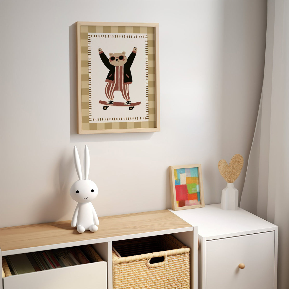 Skateboard bear checker border nursery print in an oak frame above a kids cubby shelf with a woven basket and bunny lamp
