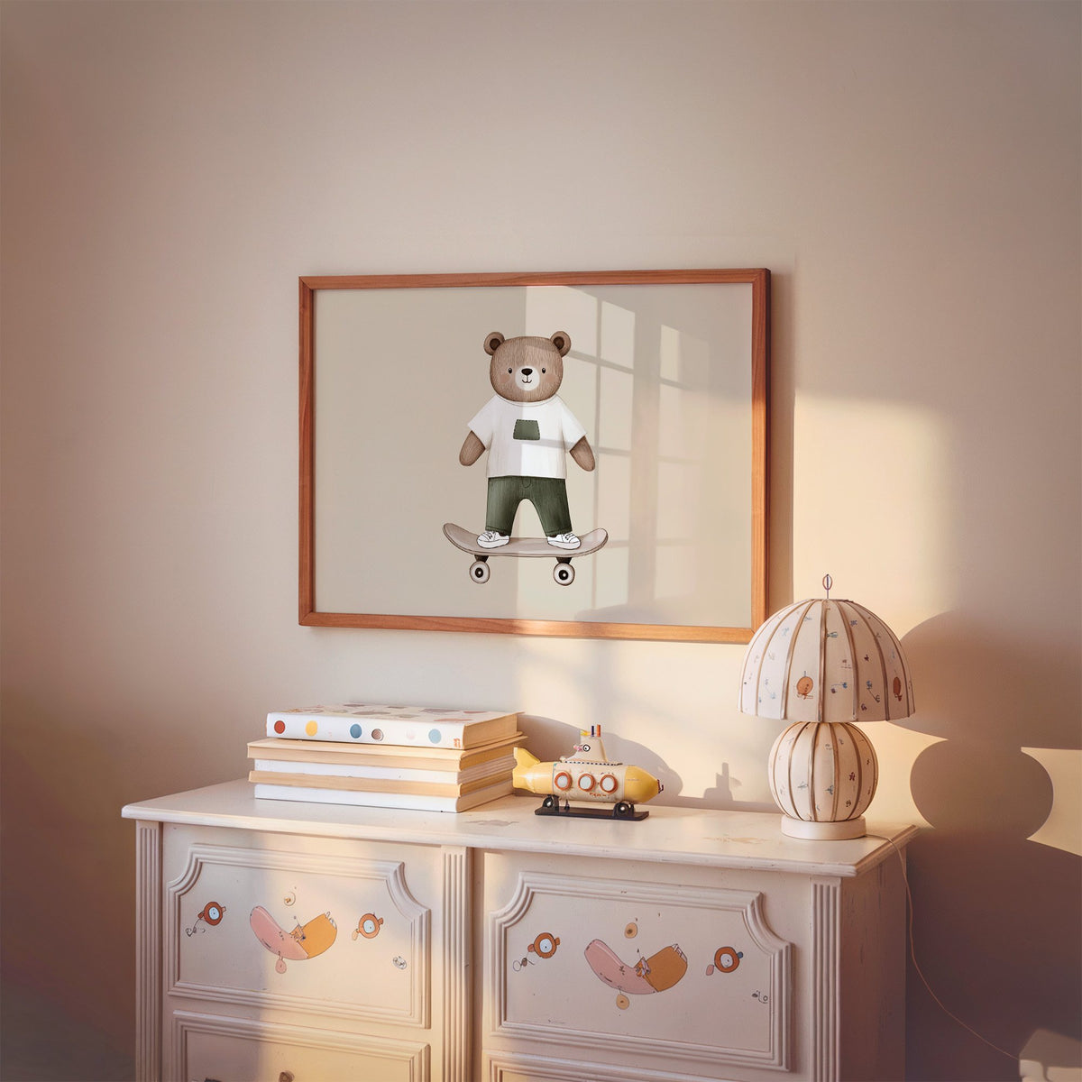 Landscape skateboard bear white tee nursery print in a cherry wood frame above a painted dresser and lamp