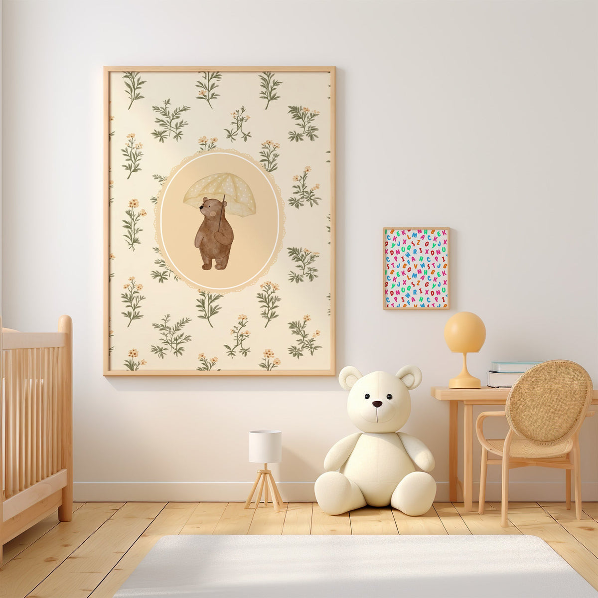 Bear with a polka dot yellow umbrella nursery print in an oak frame above a wooden crib beside a cream teddy bear