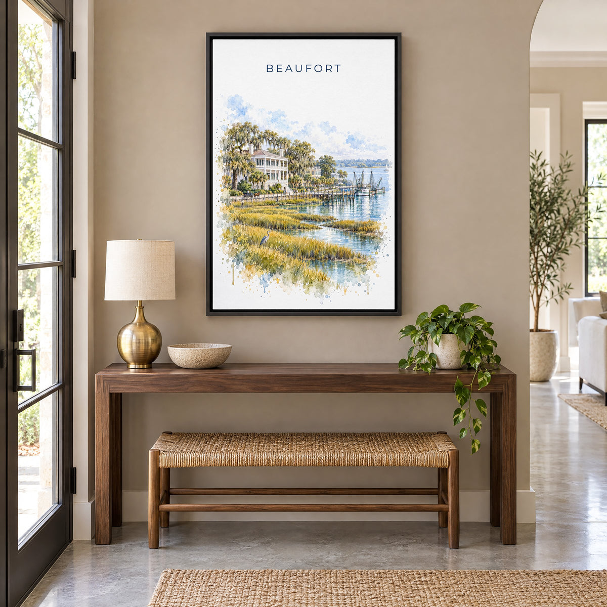 Beaufort, South Carolina watercolor print as a black floater canvas above a walnut console and woven bench in an entryway