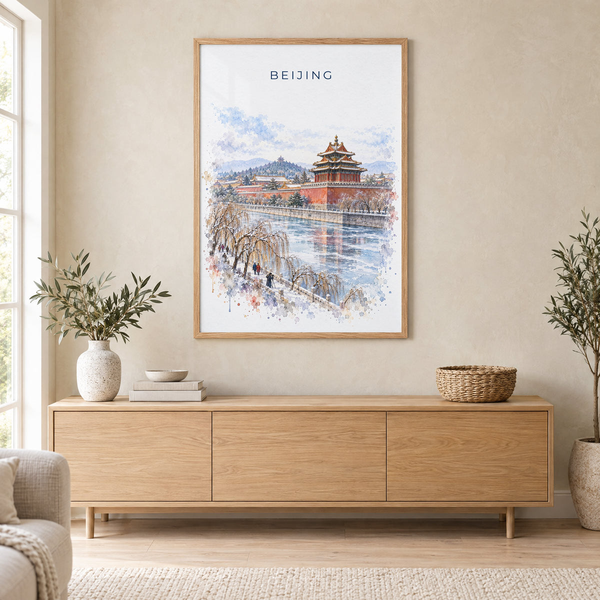 Beijing watercolor print in an oak frame above a light wood sideboard in a Scandinavian living room